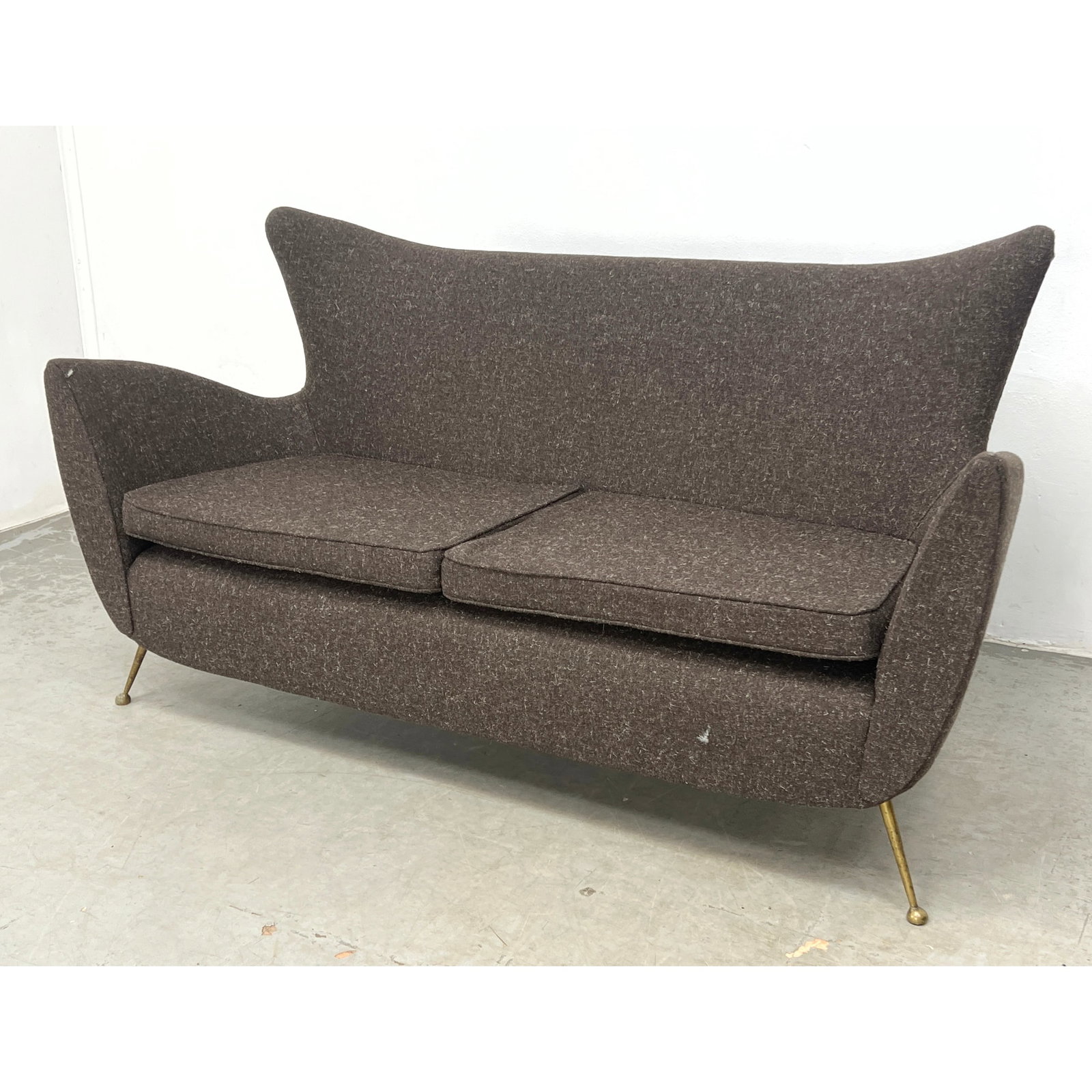 Mid Century Modern Italian Gigi Radice Style Sofa Couch. The piece is defined by a high, flared wing: Mid Century Modern Italian Gigi Radice Style Sofa Couch. The piece is defined by a high, flared wing back and low, integrated armrests that sweep outward Dimensions: Height: 33 inches, Width: 59 inche