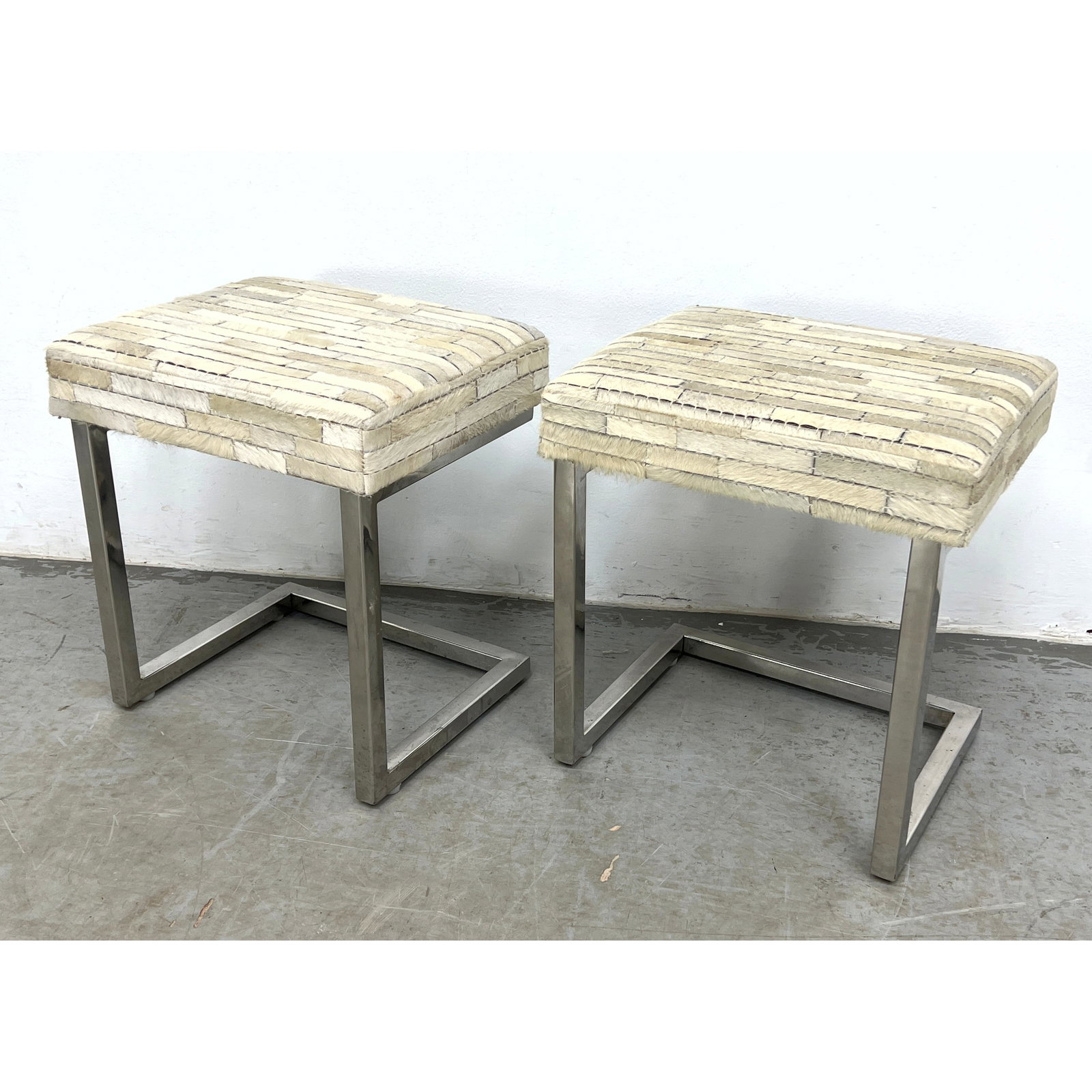 Pair cantilevered accent stools featuring square-profile polished metal frames. (1 of 9)