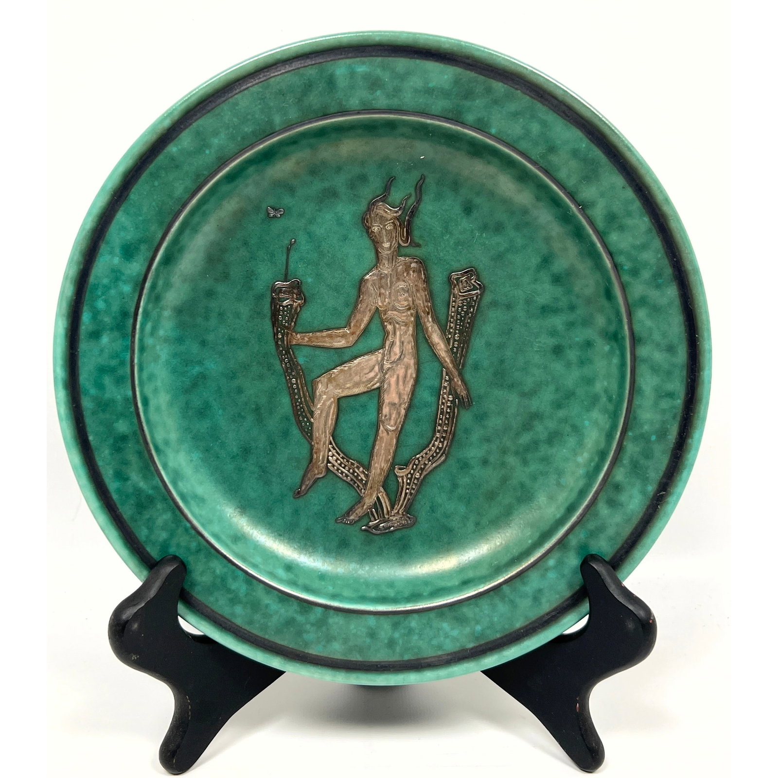 Swedish GUSTAVSBERG Argenta Pottery Plate. The circular stoneware dish features a mottled green glaz: Swedish GUSTAVSBERG Argenta Pottery Plate. The circular stoneware dish features a mottled green glaze characteristic of the series. The central field is decorated with silver overlay depicting a styli