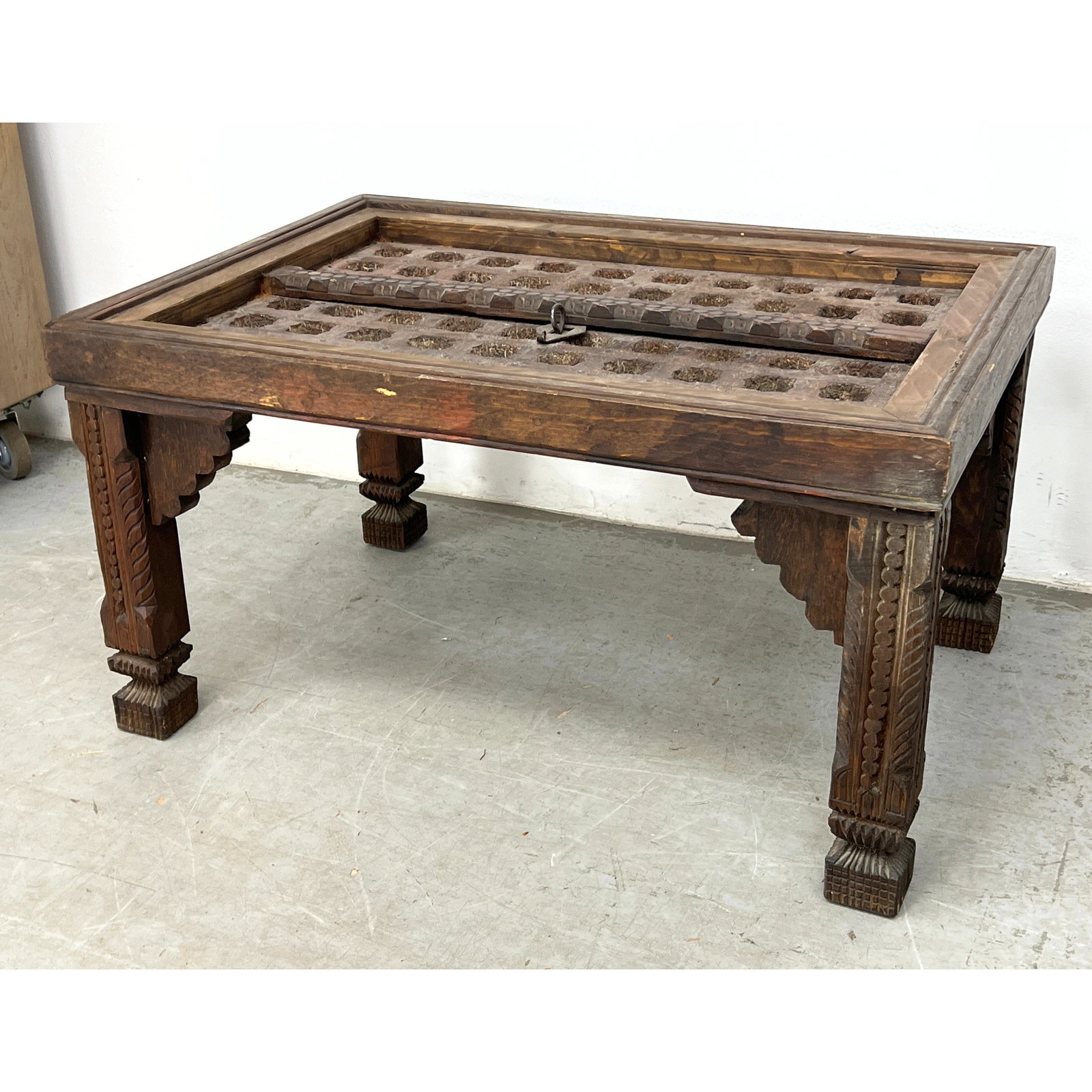 Low coffee table is constructed from repurposed Indian architectural elements, specifically a hand-c (1 of 8)