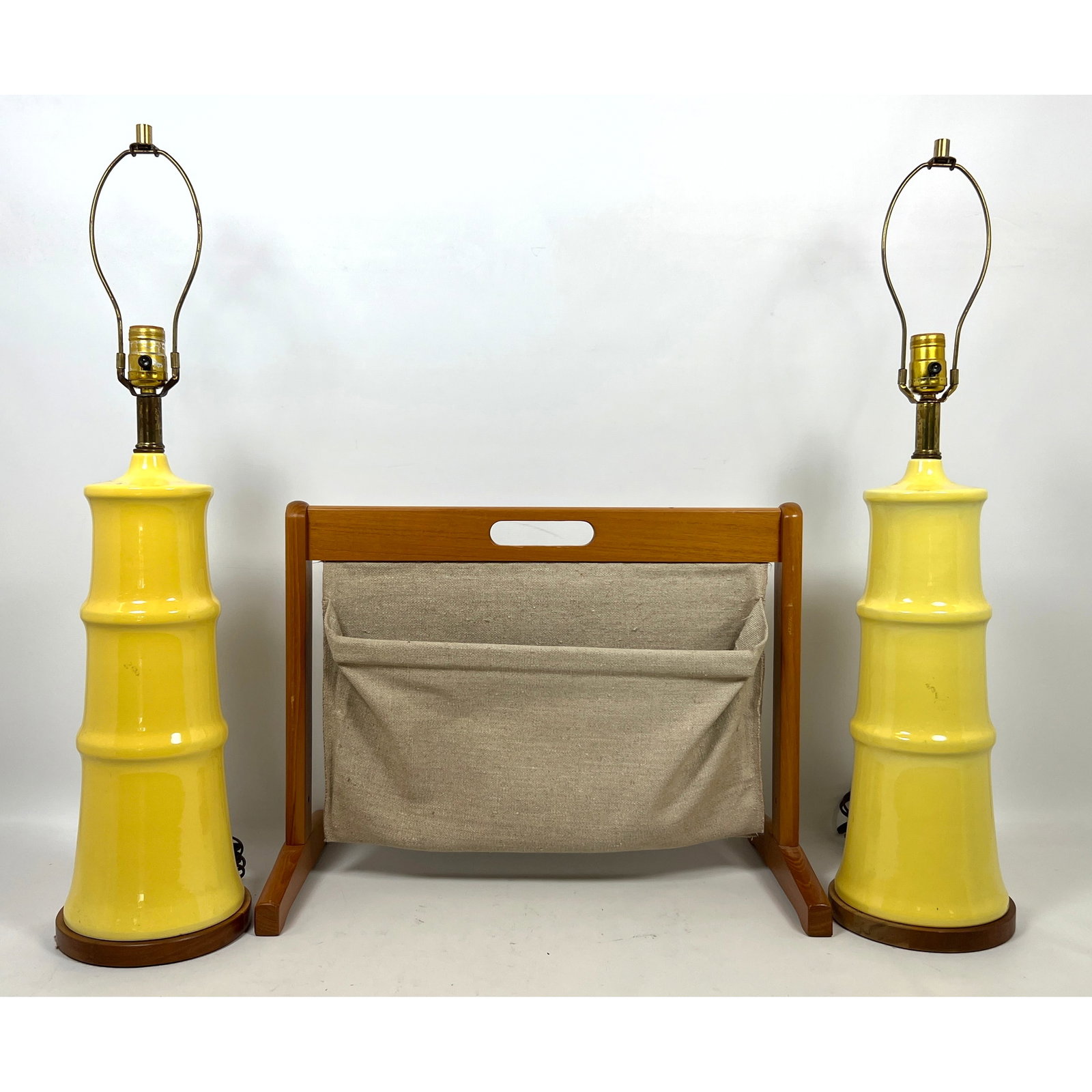 Mid Century Modern Lot. Pair Yellow Pottery Table Lamps and Teak Furbo Magazine Rack with Fabric Sli: Mid Century Modern Lot. Pair Yellow Pottery Table Lamps and Teak Furbo Magazine Rack with Fabric Sling. Dimensions: Height: 30 inches, Width: 7 inches, Depth: 7 inches. - Additional Dimensions: Magazi