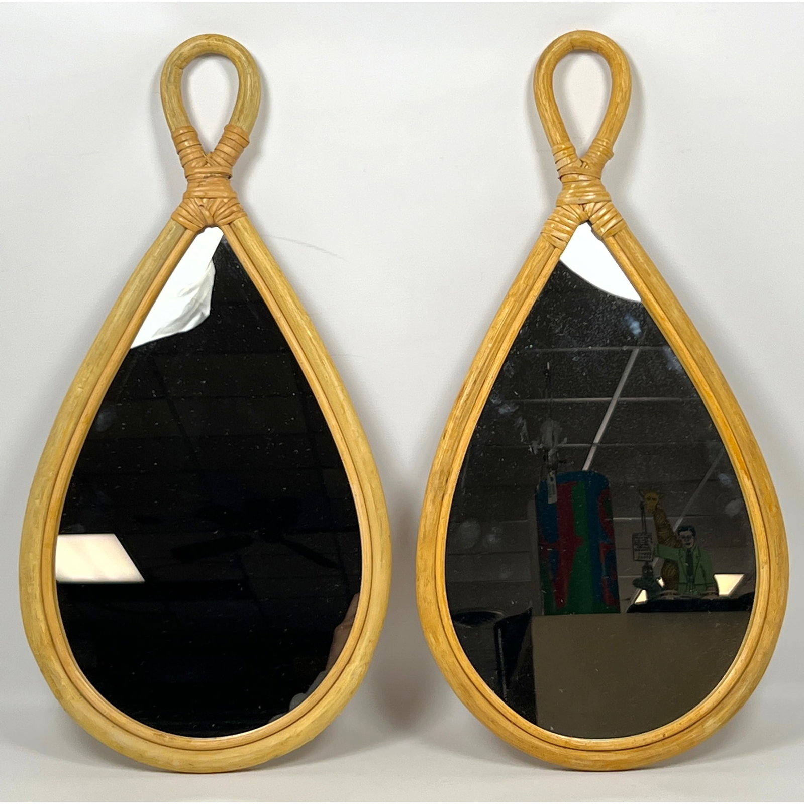 Pair Matching Rattan Bamboo Wall Mirrors. Tear Drop form.: Pair Matching Rattan Bamboo Wall Mirrors. Tear Drop form. Dimensions: Height: 22 inches, Width: 11 inches. --- US Packing and Shipping charge: In house shipping available. Will be calculated once