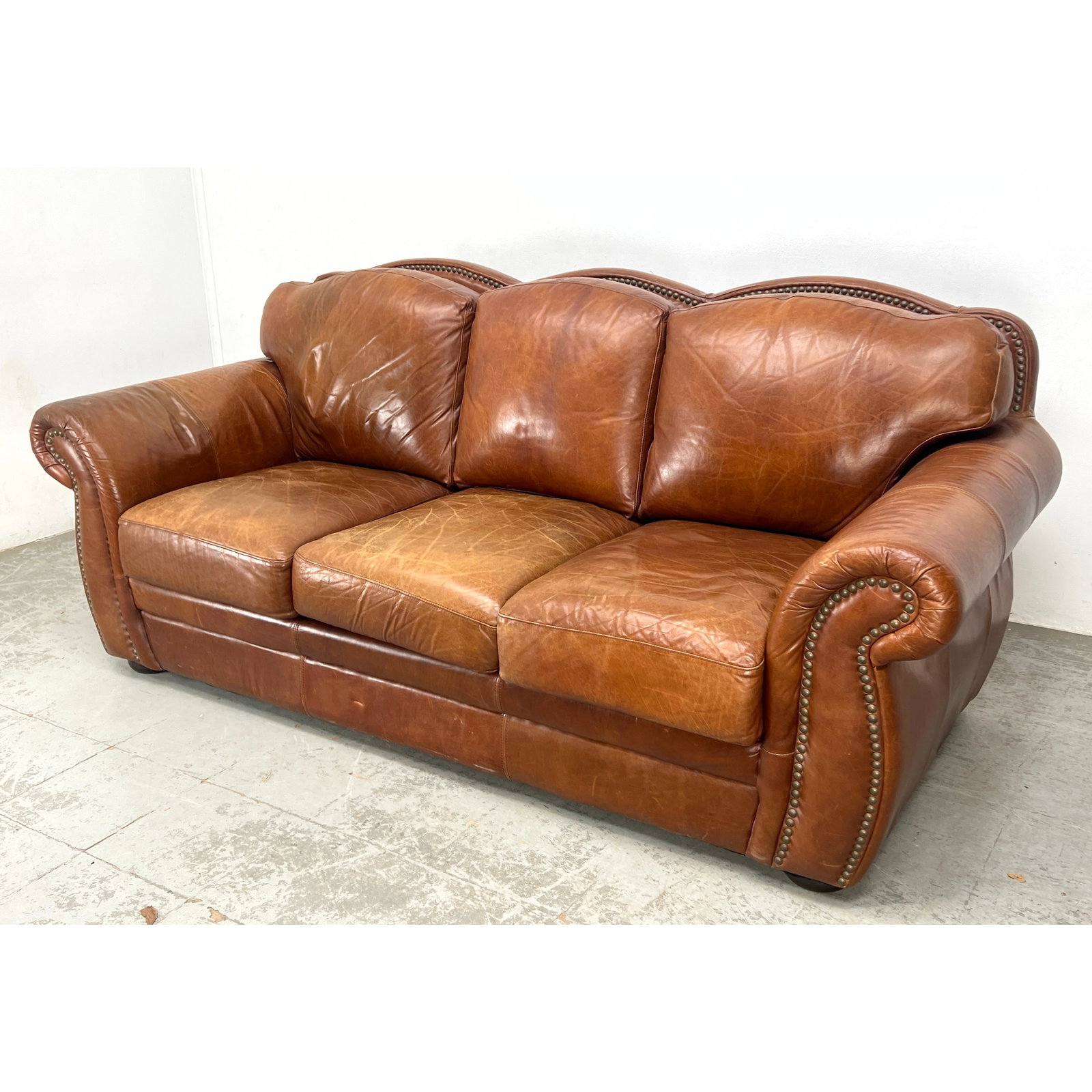 Robertson and Robertson Distressed Leather Sofa with decorative brass nail heads surrounding. (1 of 11)