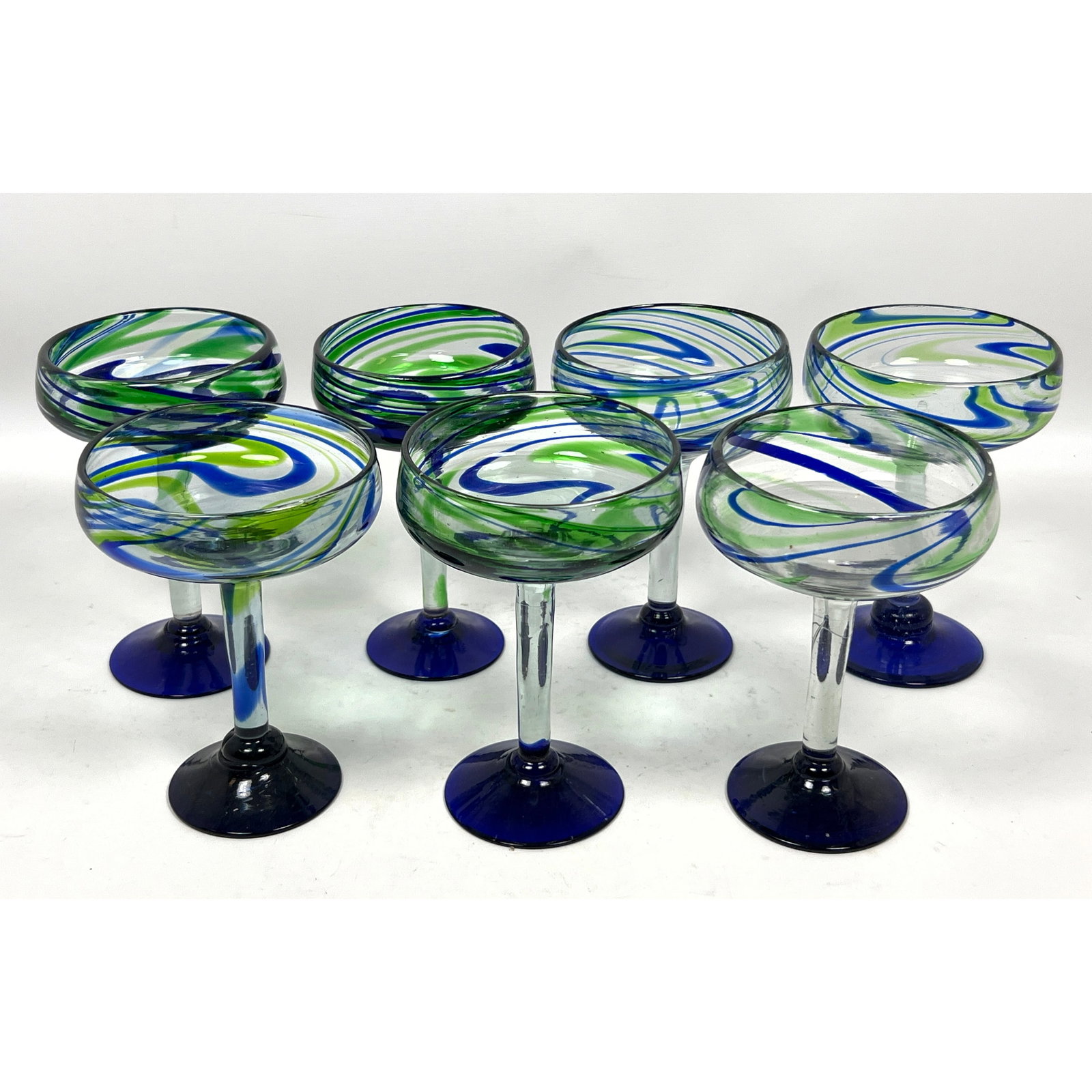 Set 7 Art Glass Swirl Champagne Glasses.: Set 7 Art Glass Swirl Champagne Glasses. Dimensions: Height: 7 inches, Width: 4.5 inches, Depth: 4.5 inches. --- US Packing and Shipping charge: In house shipping available. Will be calculated once de