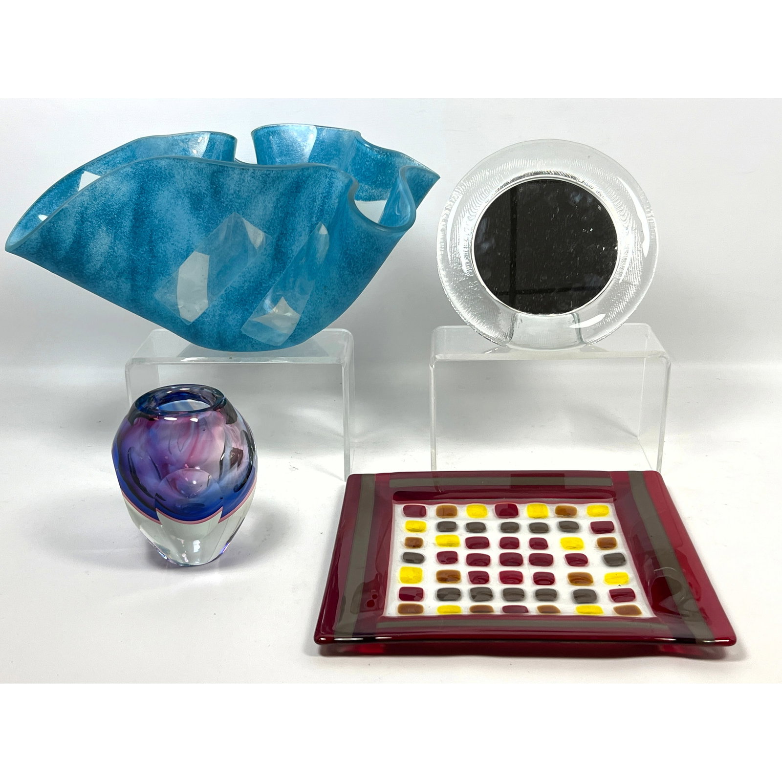 Modernist Glass Lot. Signed ribbon art glass bowl, Small table mirror, Faceted art glass vase, Fused: Modernist Glass Lot. Signed ribbon art glass bowl, Small table mirror, Faceted art glass vase, Fused glass tray. Dimensions: Height: 7 inches, Width: 12 inches, Depth: 9 inches. ---