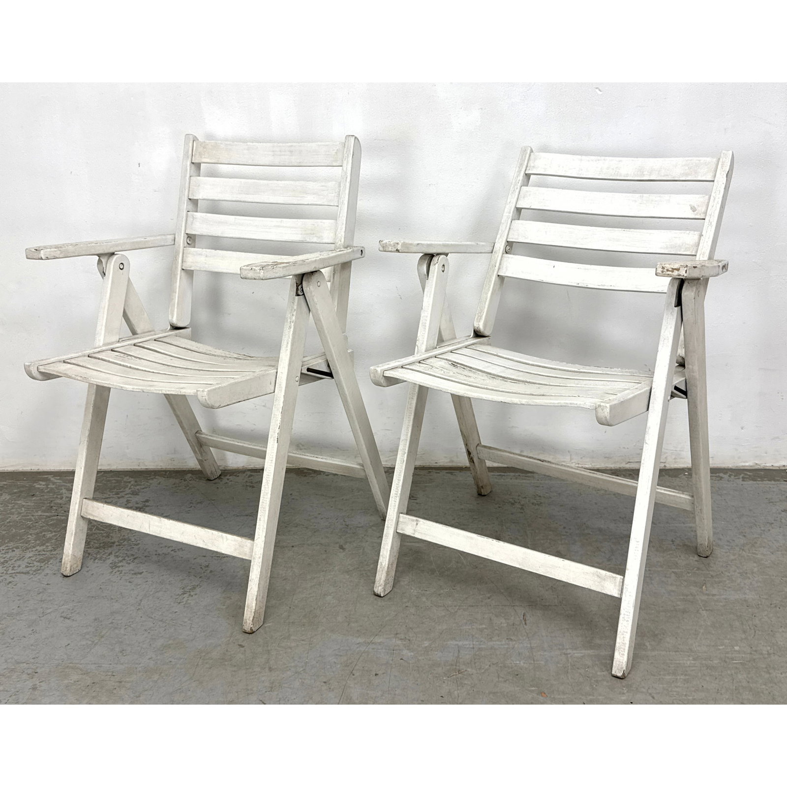 Pair of wooden folding armchairs designed for garden or patio use: Pair of wooden folding armchairs designed for garden or patio use Dimensions: Height: 33.25 inches, Width: 23.5 inches, Depth: 22 inches. - Seat Height: 18 inches ---