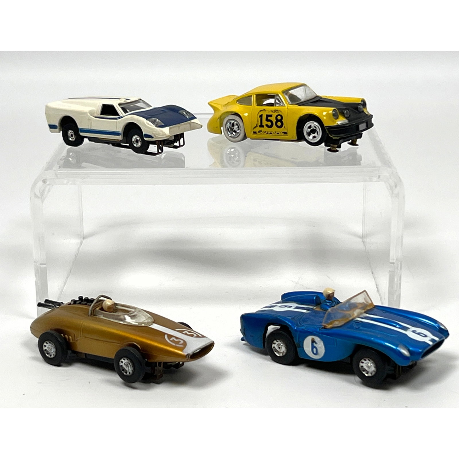 4 vintage HO-scale electric slot cars manufactured by Tyco and Tycopro. The models are constructed w: 4 vintage HO-scale electric slot cars manufactured by Tyco and Tycopro. The models are constructed with molded plastic bodies and feature both metal and plastic chassis components. Each vehicle is equ