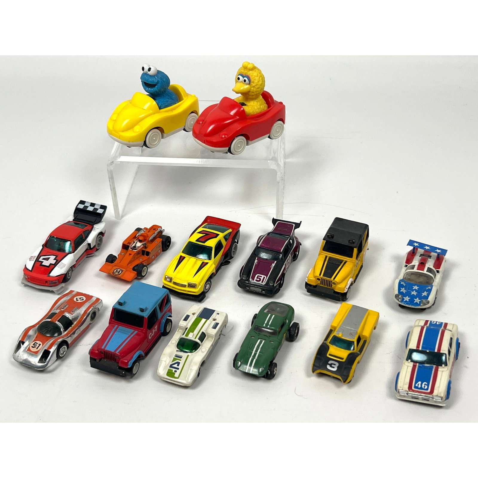 16 vintage toy vehicles including 14 HO scale slot cars and two motorized character toys. The charac (1 of 20)