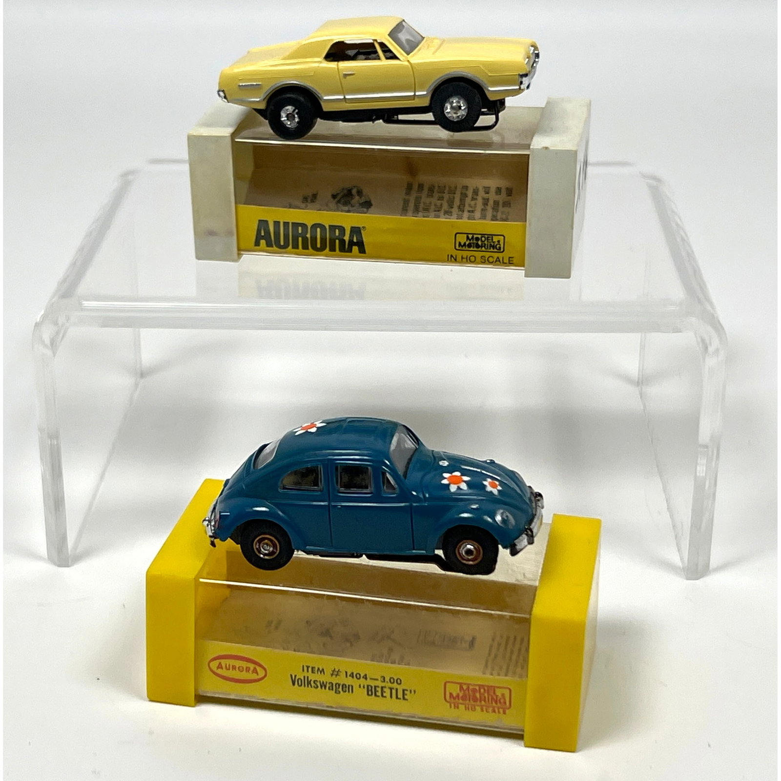 2 vintage Aurora Model Motoring HO scale slot cars, each presented in a plastic display box. The fir (1 of 17)