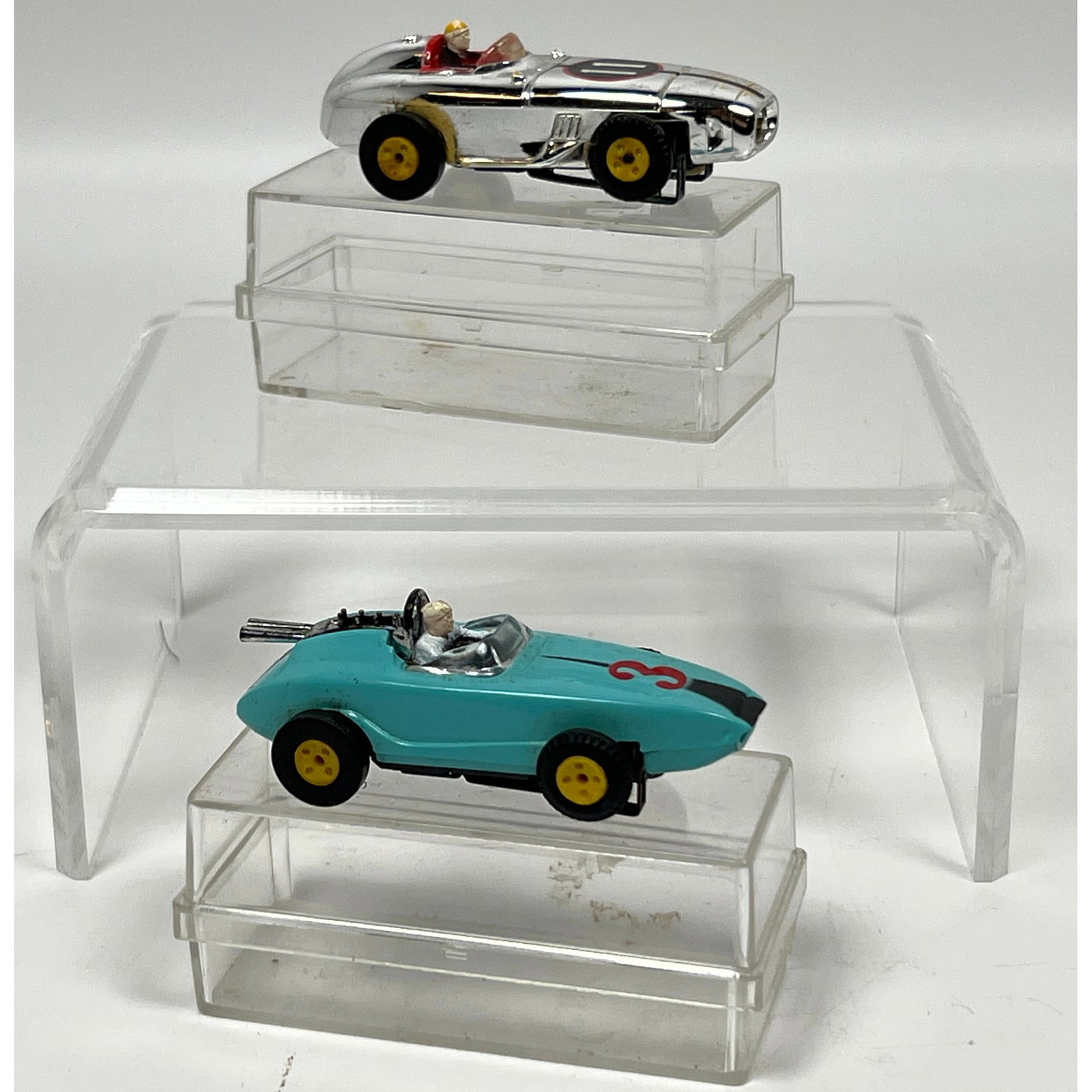 2 vintage HO scale electric slot cars featuring plastic bodies and chassis designs consistent with t (1 of 15)