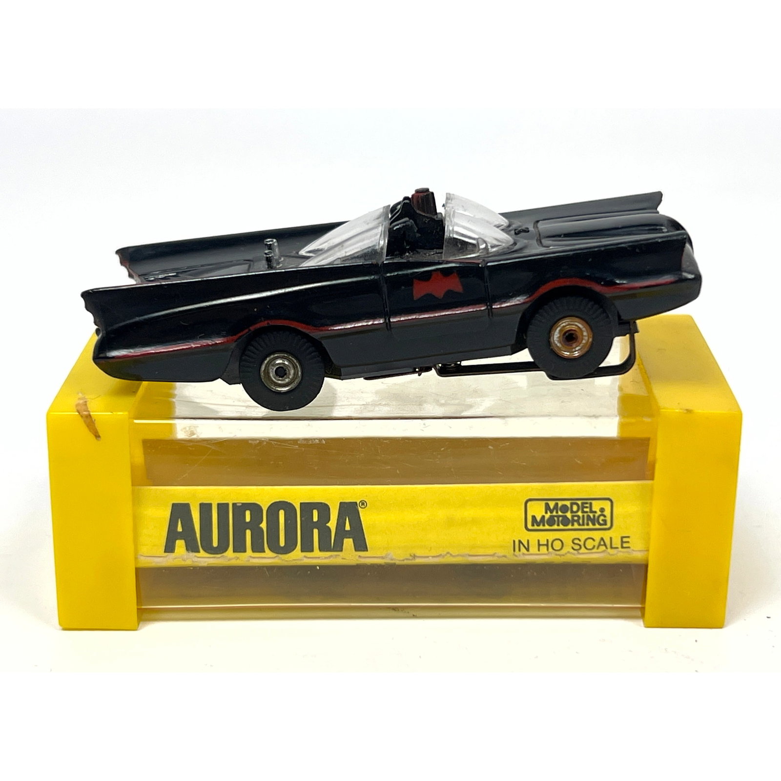 An original Aurora Model Motoring HO scale slot car modeled after the 1966 television series Batmobi: An original Aurora Model Motoring HO scale slot car modeled after the 1966 television series Batmobile. The vehicle is constructed with a black plastic body featuring red pinstriping and red bat wing 