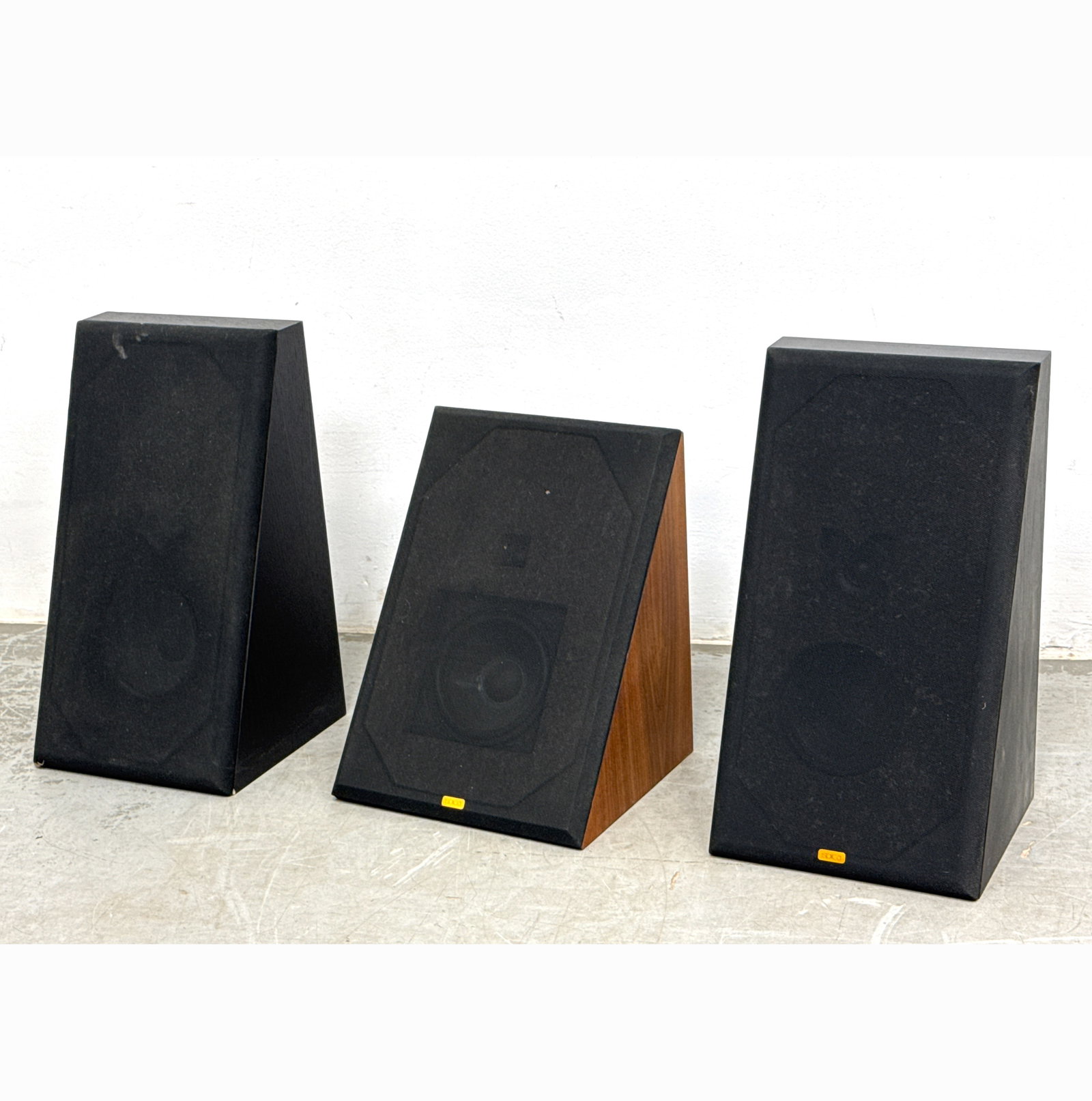 Pair of Spica TC-60 loudspeakers featuring a distinctive slanted, wedge-shaped cabinet design.: Pair of Spica TC-60 loudspeakers featuring a distinctive slanted, wedge-shaped cabinet design. Dimensions: Height: 20.25 inches, Width: 11.5 inches, Depth: 11 inches. ---