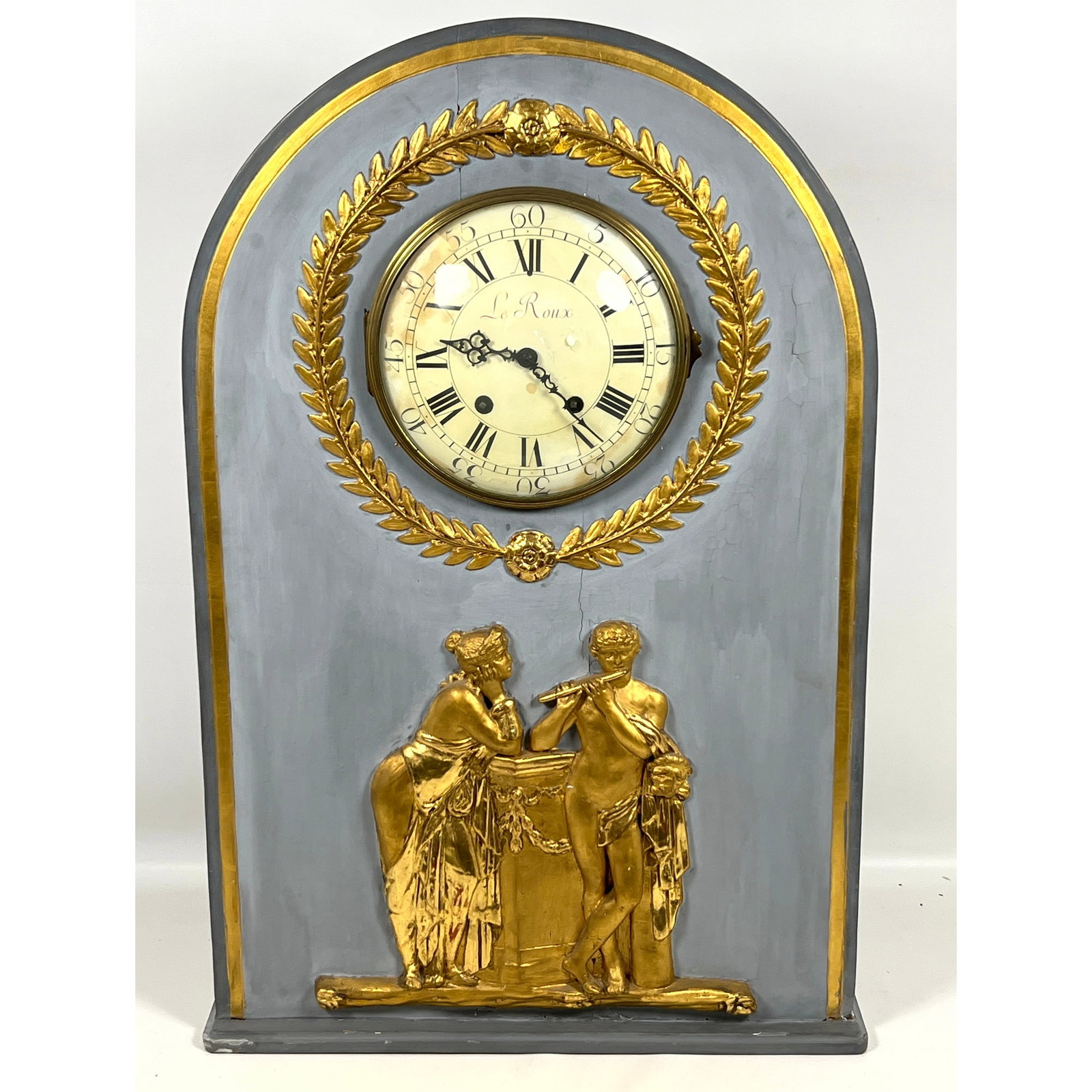 Large Neoclassical style mantel clock featuring an arched wooden case finished in gray paint with gi: Large Neoclassical style mantel clock featuring an arched wooden case finished in gray paint with gilded accents. Dial Marked Le Roux. Dimensions: Height: 33 inches, Width: 21 inches, Depth: 6