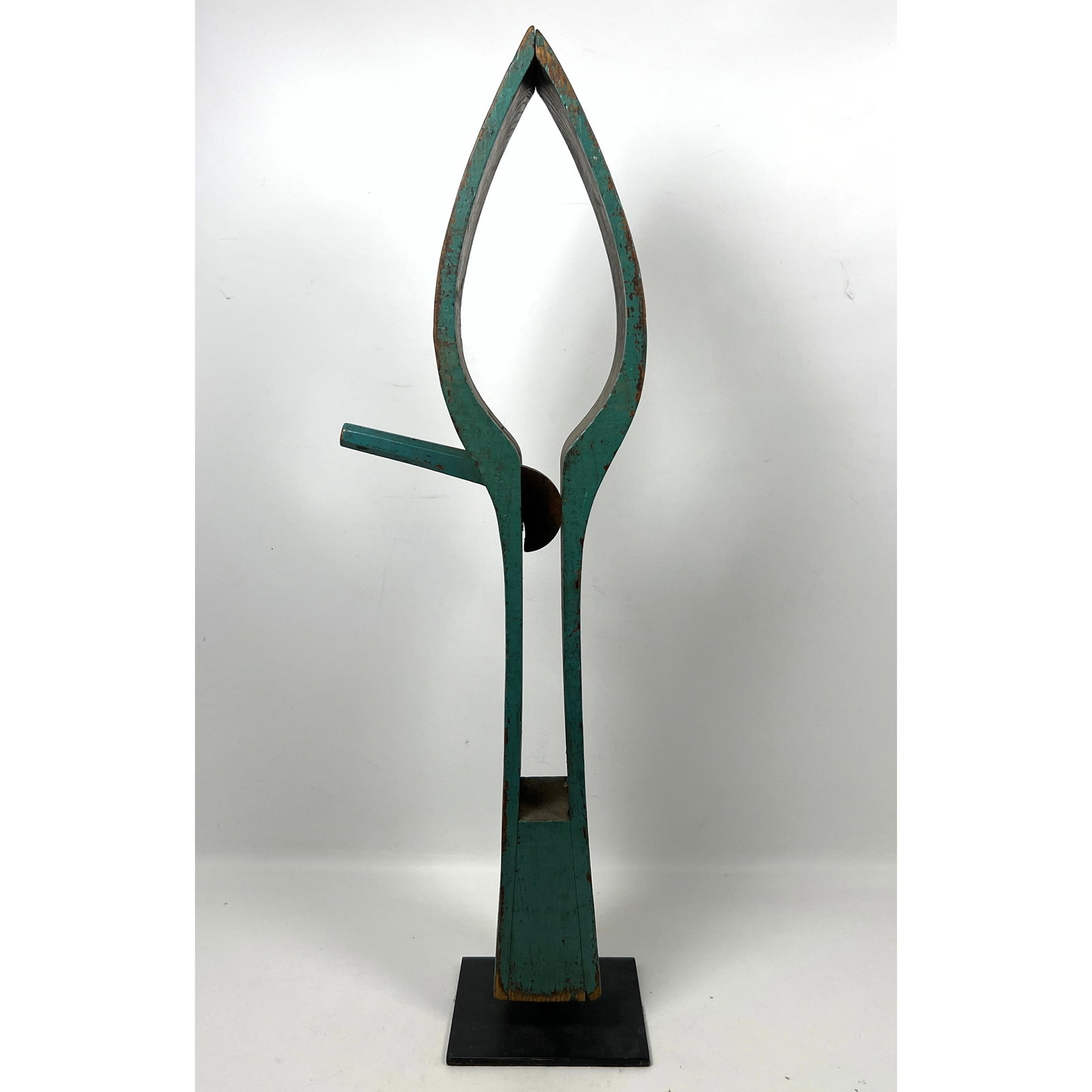 A tall, antique wooden clamp, commonly known as a stitching pony or saddle makers vice, repurposed a: A tall, antique wooden clamp, commonly known as a stitching pony or saddle makers vice, repurposed and presented as a piece of abstract folk art sculpture Dimensions: Height: 29.5 inches, Width: 9 inc