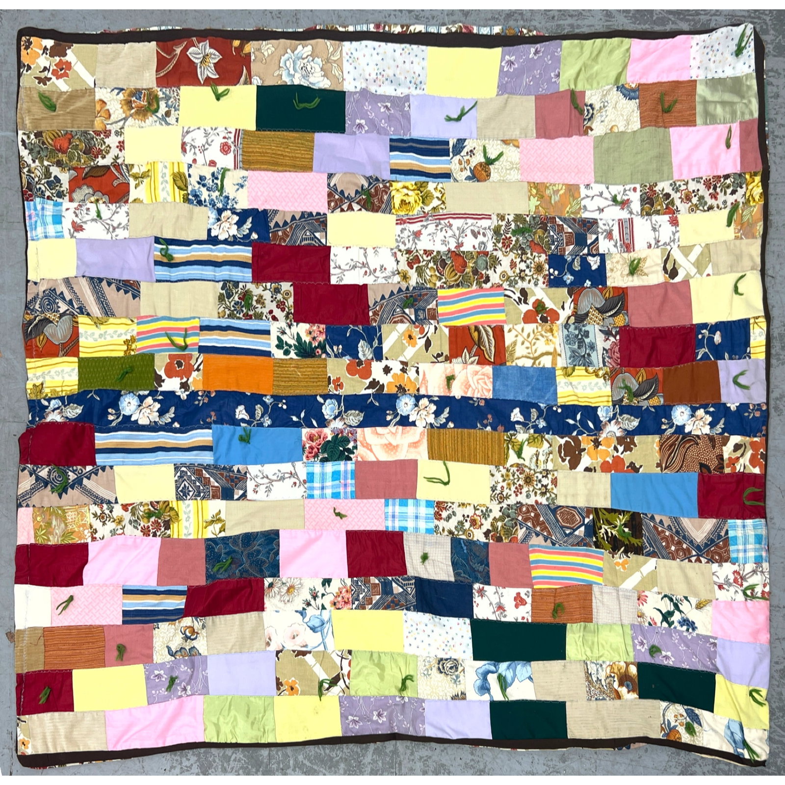 Vintage patchwork tied quilt features a staggered rectangular block. Machine made. (1 of 6)