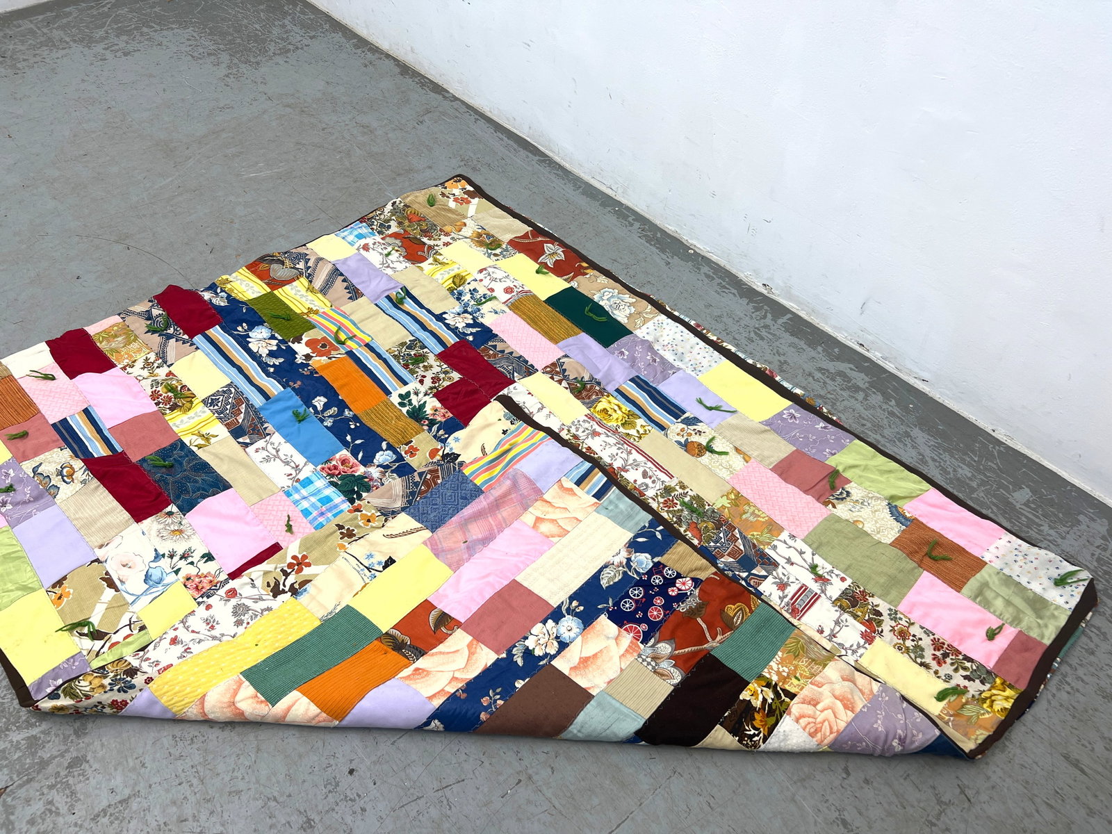 Vintage patchwork tied quilt features a staggered rectangular block. Machine made. - 2