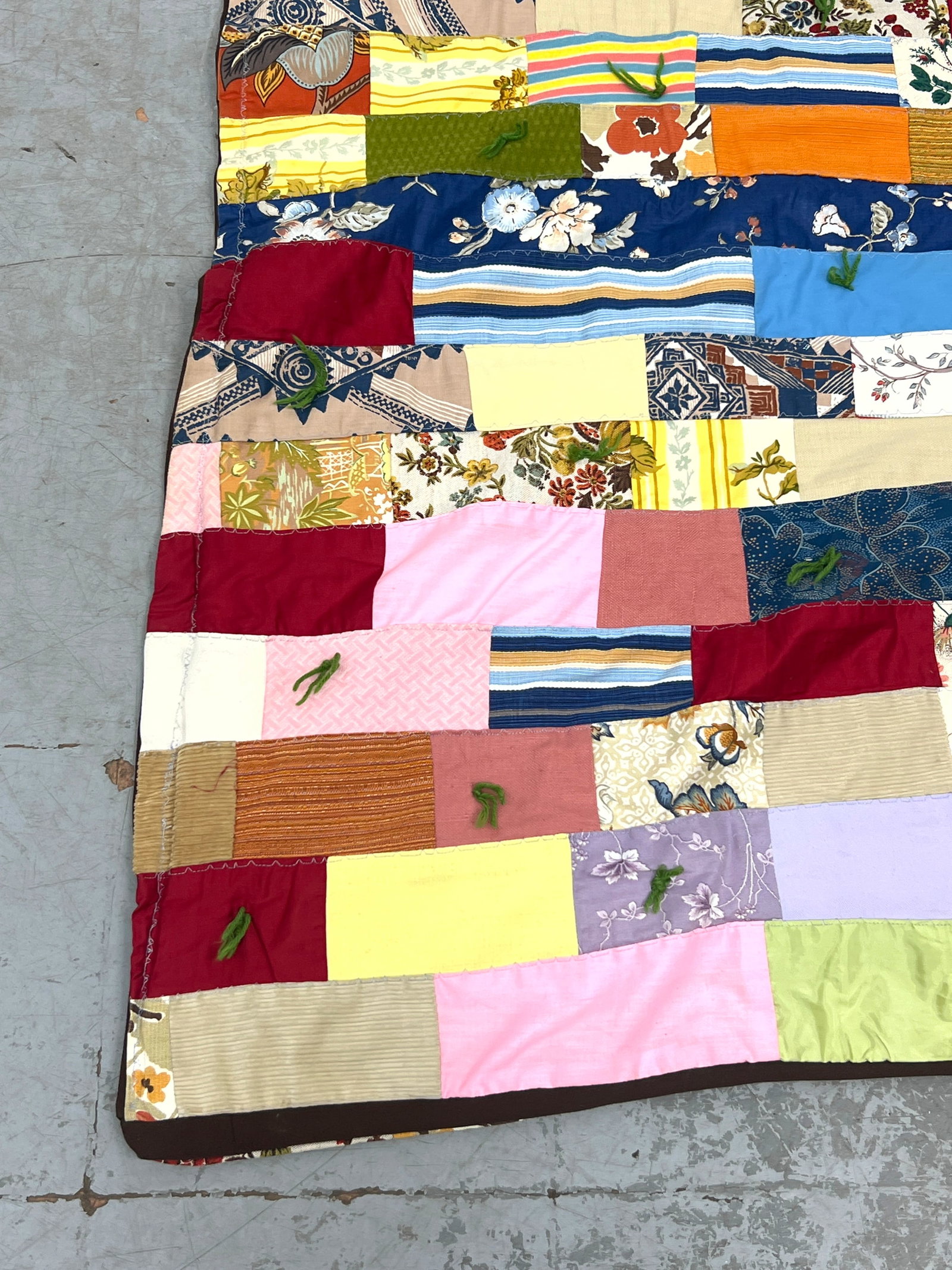 Vintage patchwork tied quilt features a staggered rectangular block. Machine made. - 4