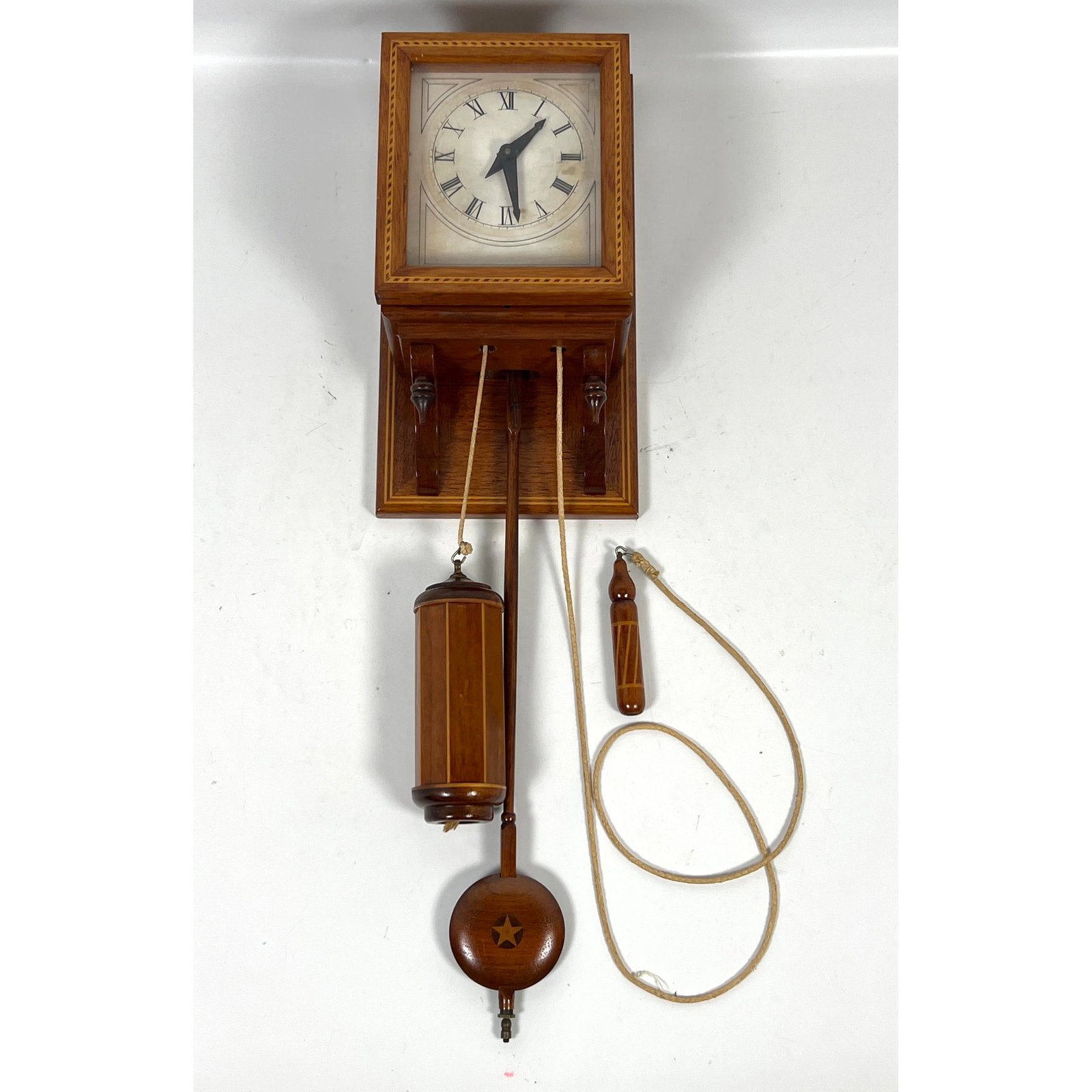 Wall-mounted hooded clock featuring a mechanical wooden-works movement, attributed to artisan Charle: Wall-mounted hooded clock featuring a mechanical wooden-works movement, attributed to artisan Charles Alvah Smith of Brattleboro, Vermont. Dimensions: Height: 24 inches, Width: 7 inches, Depth: 5