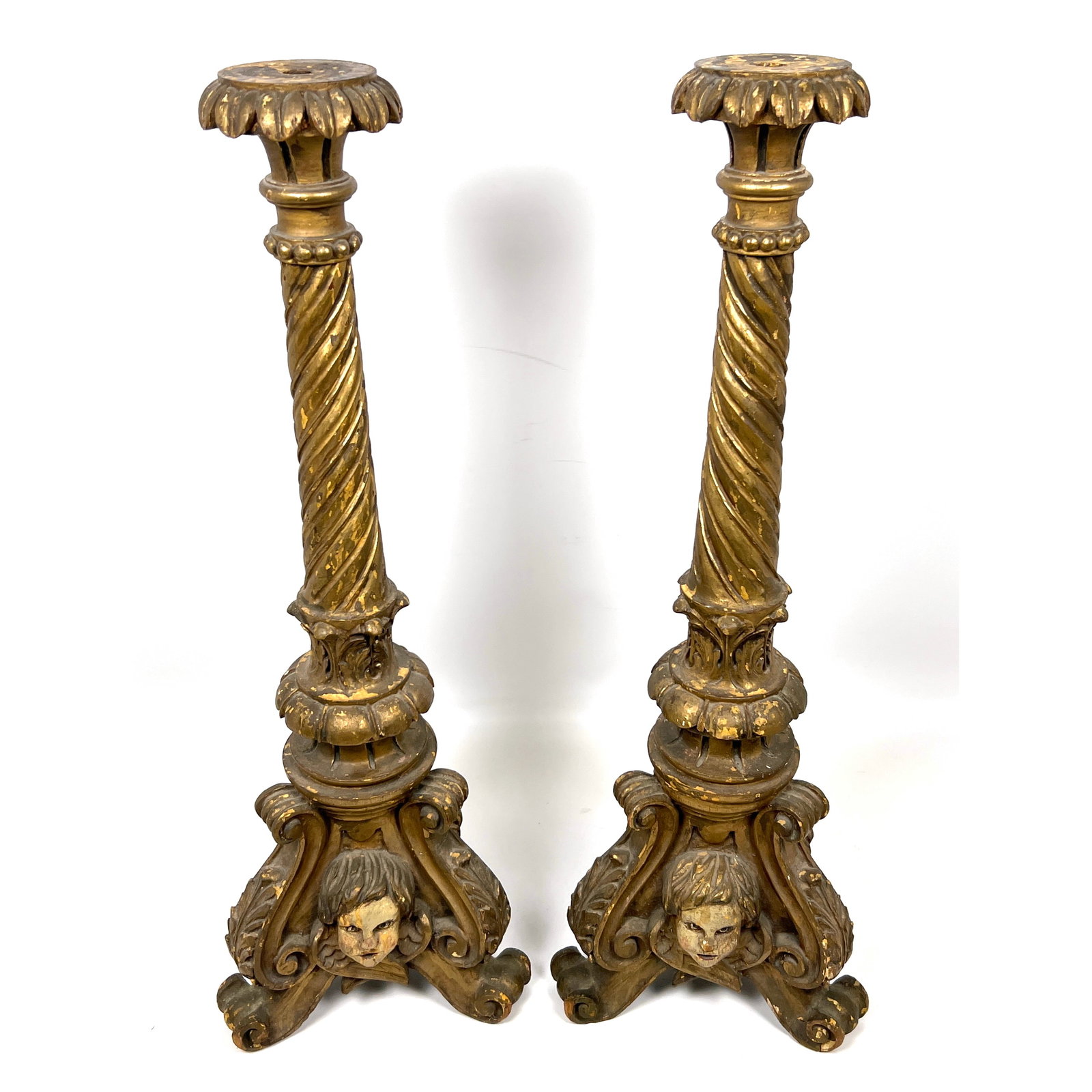 Pair of large carved wood candlesticks rendered in the Italian Baroque style with a distressed gilt: Pair of large carved wood candlesticks rendered in the Italian Baroque style with a distressed gilt and polychrome finish. Dimensions: Height: 24 inches, Width: 8 inches, Depth: 8 inches. ---