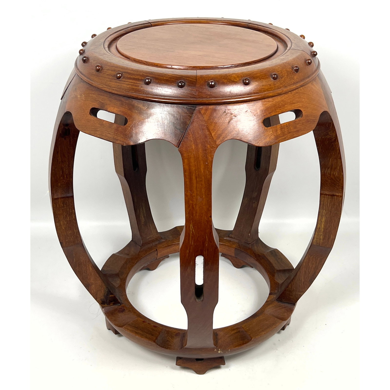 Chinese-style hardwood drum stool, also known as a zuodun, of barrel form: Chinese-style hardwood drum stool, also known as a zuodun, of barrel form Dimensions: Height: 18 inches, Width: 16 inches, Depth: 16 inches. ---