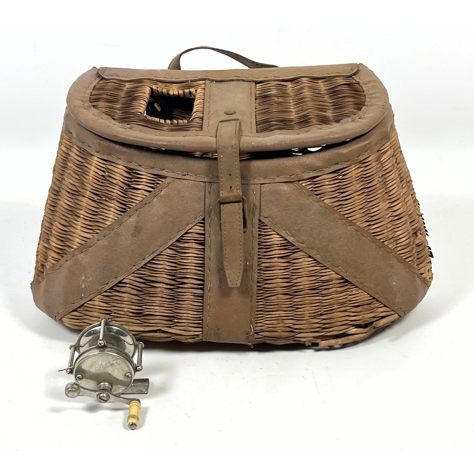 Vintage fishing equipment consisting of a woven wicker creel, a Chief metal reel, (1 of 13)