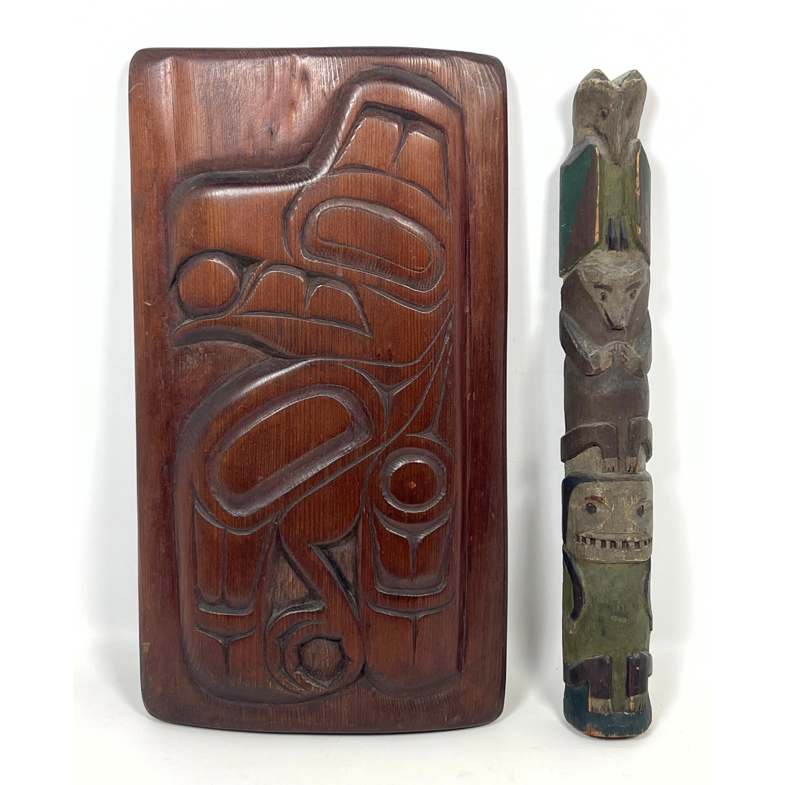2pcs wood carvings in the Northwest Coast tradition, including a rectangular relief-carved plaque an: 2pcs wood carvings in the Northwest Coast tradition, including a rectangular relief-carved plaque and a polychrome model totem pole. Inuit. Remnants of old label. Dimensions: Height: 16 inches, Width: