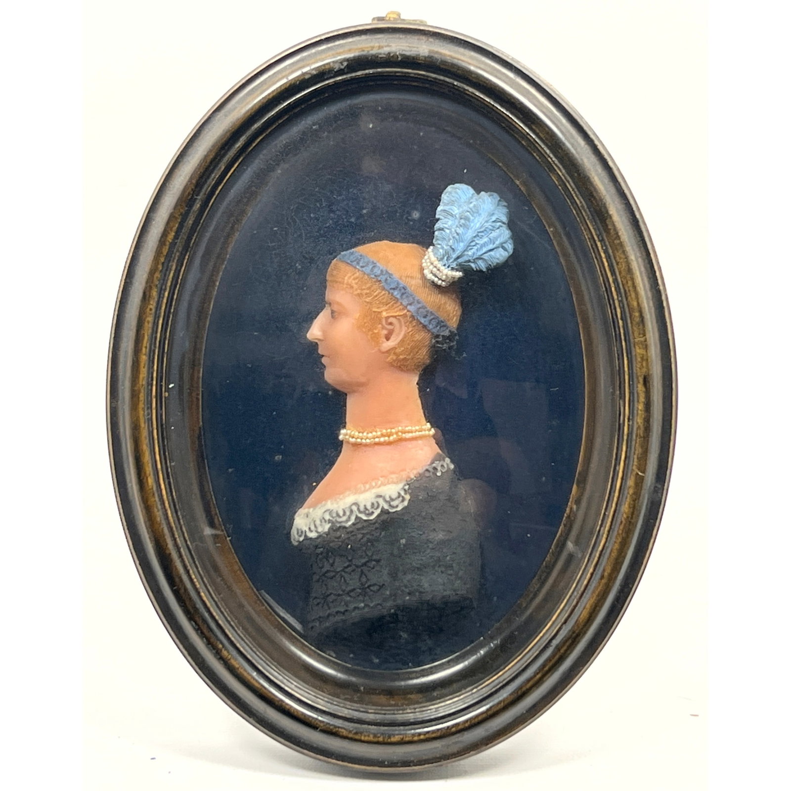 Antique polychrome wax relief portrait miniature carving sculpture. Woman in profile featuring blond: Antique polychrome wax relief portrait miniature carving sculpture. Woman in profile featuring blonde hair detailed with fine texture, a blue headband, and a blue feathered headpiece accented with row