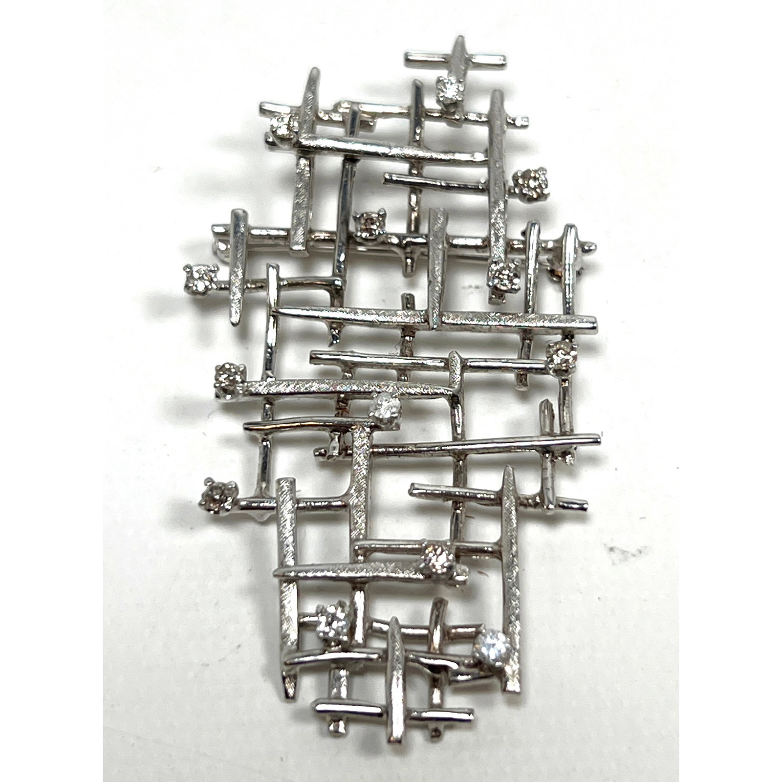 Modernist Design 10K Gold and Diamond Brooch.: Modernist Design 10K Gold and Diamond Brooch. Dimensions: Height: 2.5 inches, Width: 1.5 inches, Depth: .25 inches. Weight: 8.5 DWT --- US Packing and Shipping charge: In house shipping available. Wil