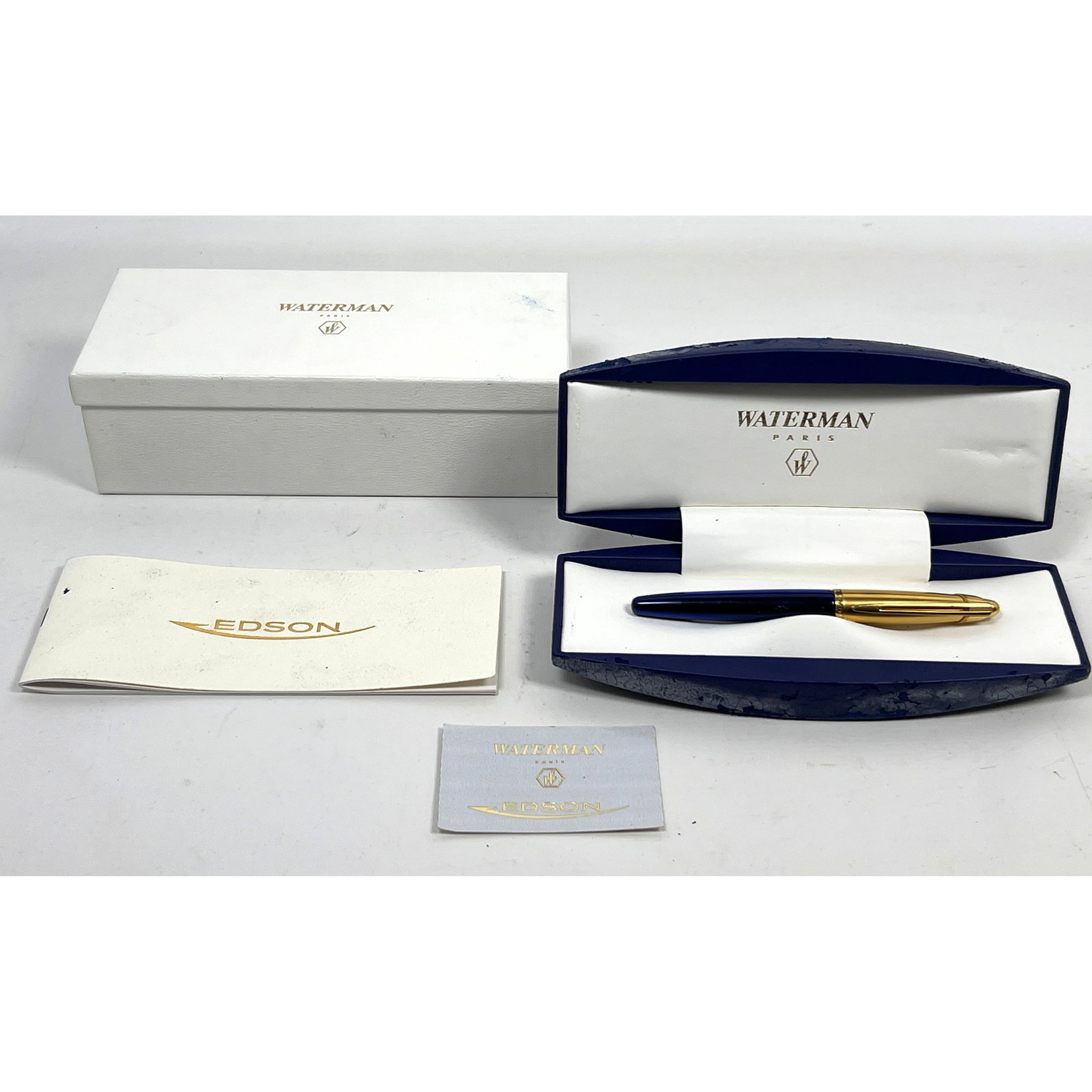 Waterman Edson fountain pen featuring a translucent sapphire blue resin barrel and a gold-plated cap: Waterman Edson fountain pen featuring a translucent sapphire blue resin barrel and a gold-plated cap. 18k Gold Tip. Porte Plume. Dimensions: Height: 3 inches, Width: 9 inches, Depth: 4 inches. --- US 