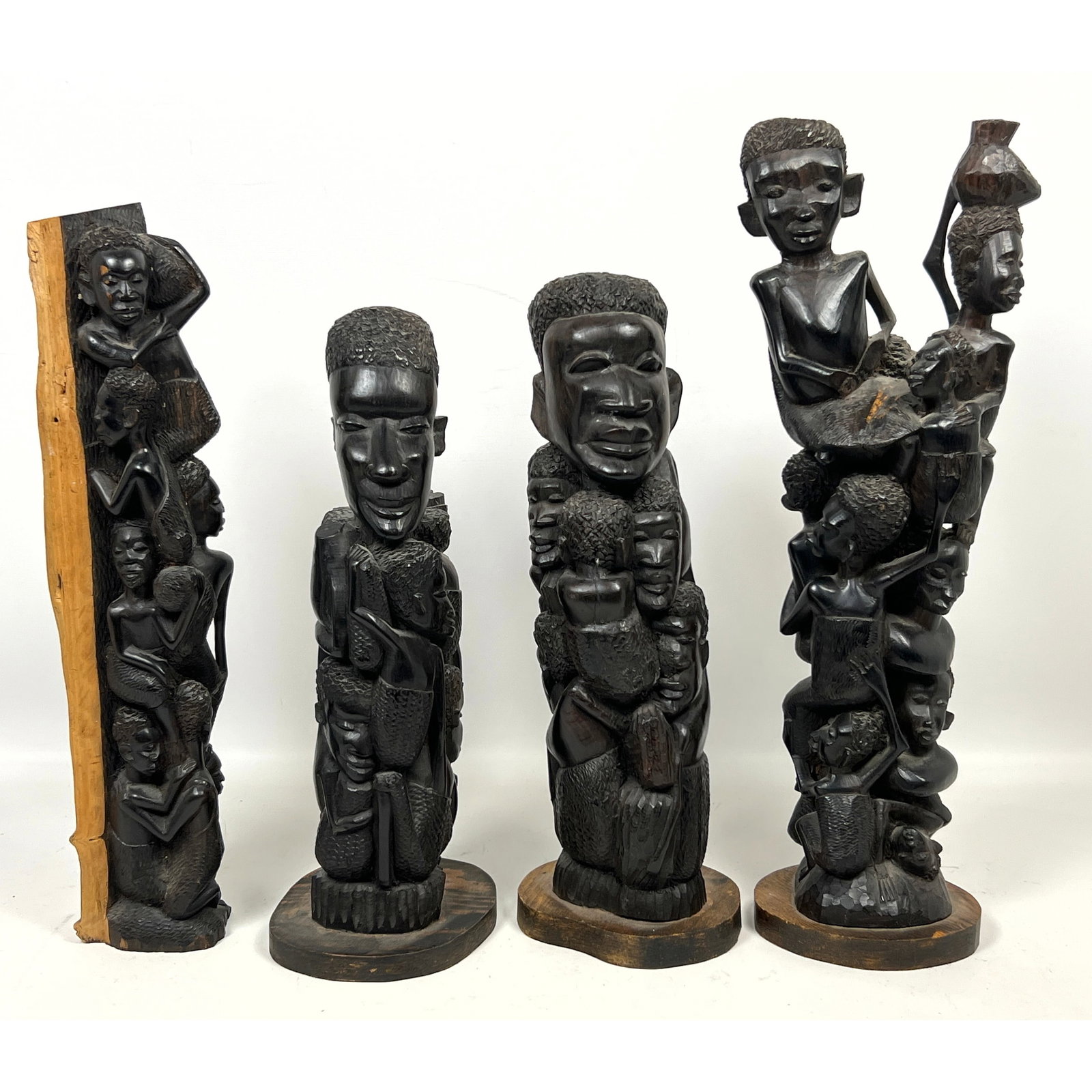4pcs East African sculptures is attributed to the Makonde style of wood carving, originating from Ta: 4pcs East African sculptures is attributed to the Makonde style of wood carving, originating from Tanzania and Mozambique. Dimensions: Height: 19 inches, Width: 6 inches, Depth: 5 inches. --- US Packi