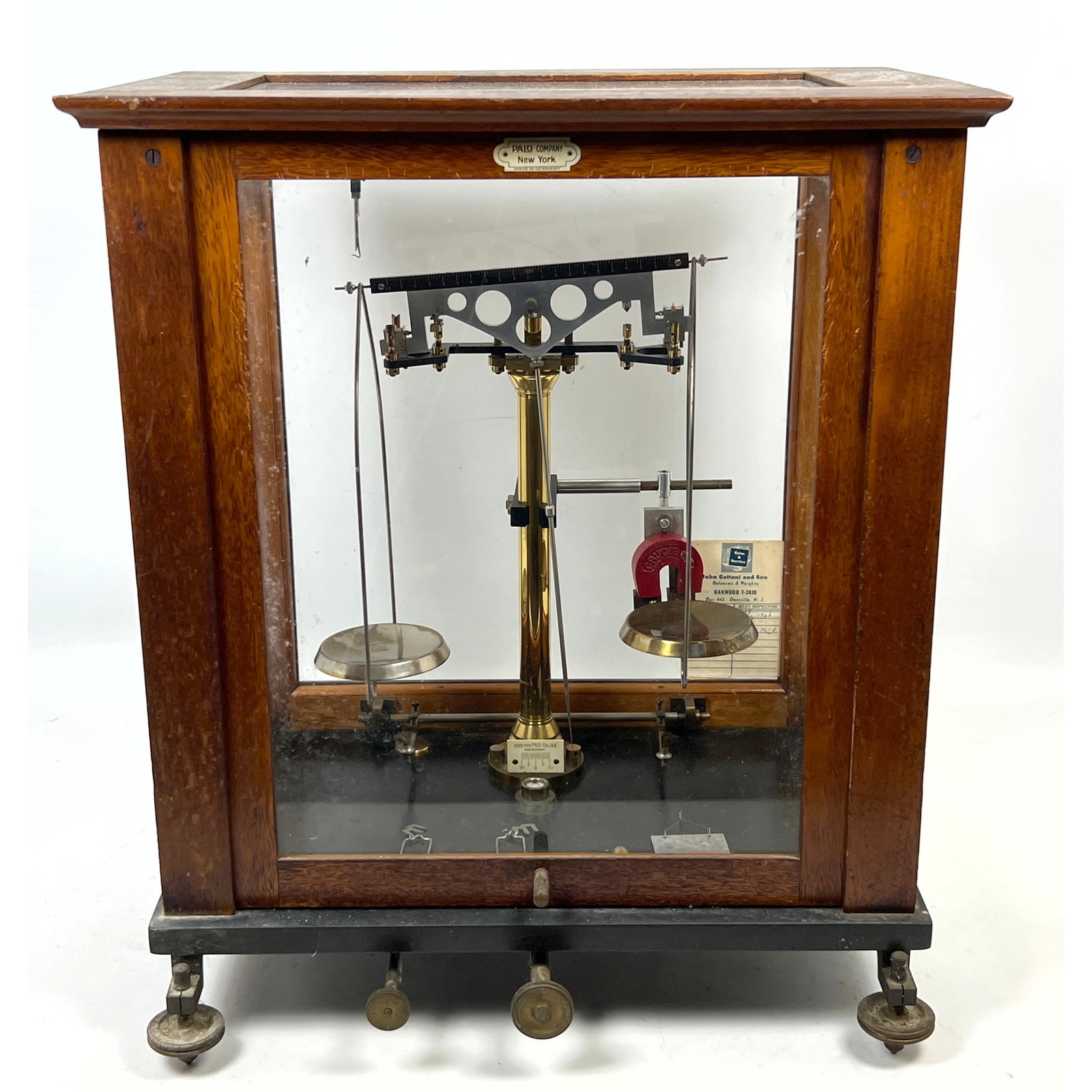 Antique dual-pan analytical balance scale manufactured for the Palo Company of New York and produced: Antique dual-pan analytical balance scale manufactured for the Palo Company of New York and produced in Germany. Dimensions: Height: 19.75 inches, Width: 17 inches, Depth: 12 inches. ---