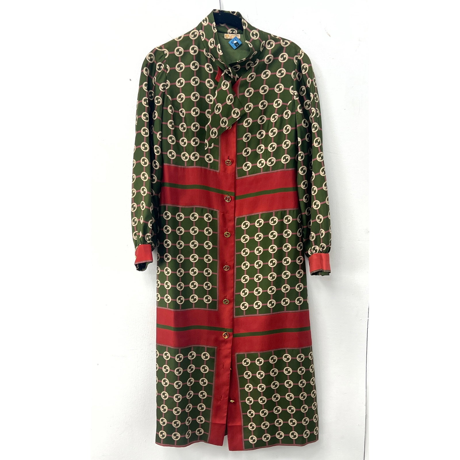 Vintage maxi-length shirt dress by Gucci, made in Italy. The garment is constructed from a forest gr: Vintage maxi-length shirt dress by Gucci, made in Italy. The garment is constructed from a forest green silk twill fabric featuring an all-over repeating interlocking double G logo print within a