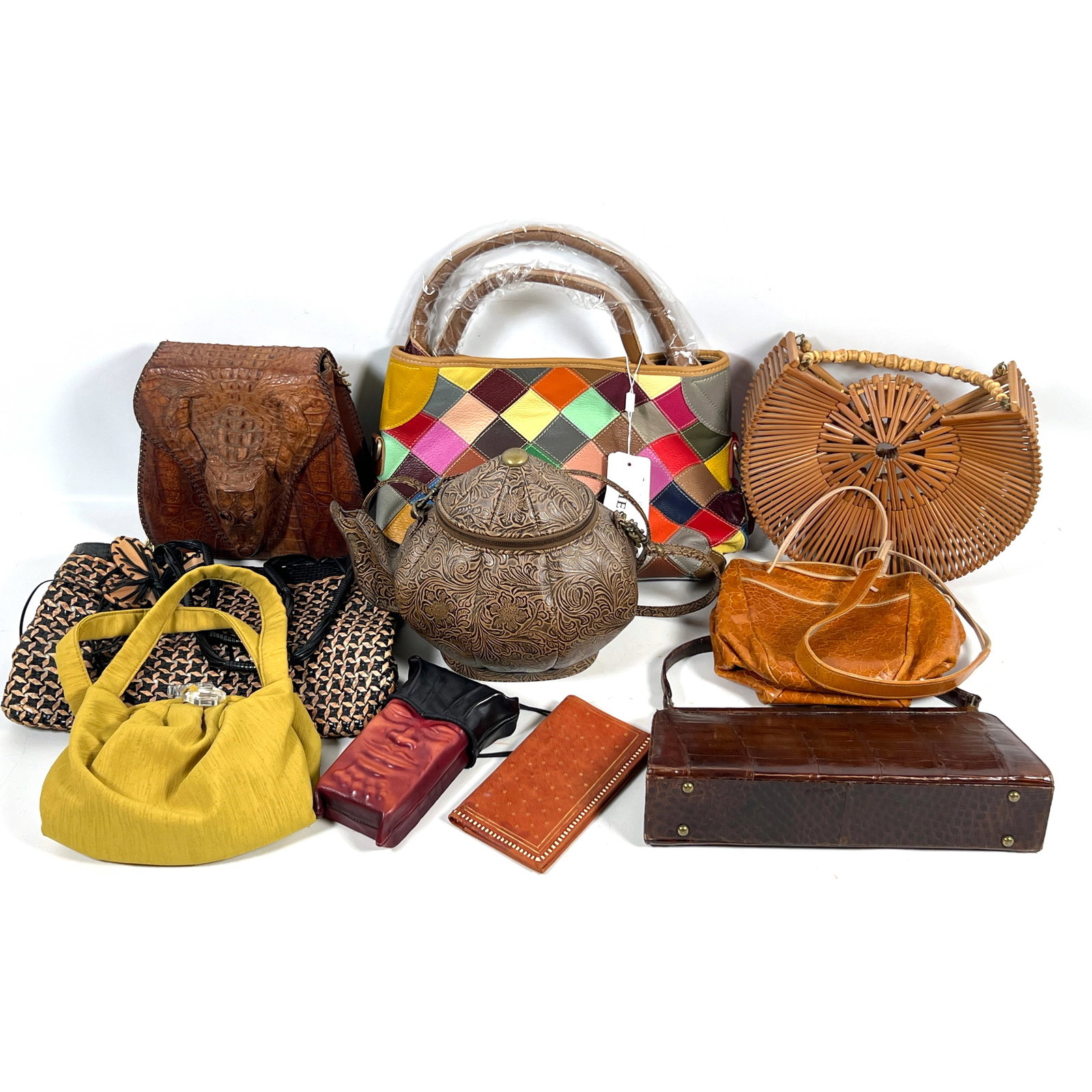 Large lot Vintage Handbags and Purses. The group includes a molded leather face pouch signed by arti: Large lot Vintage Handbags and Purses. The group includes a molded leather face pouch signed by artist D.L. Einbender with a black leather collar, cord strap, and a tassel featuring carved bone and re