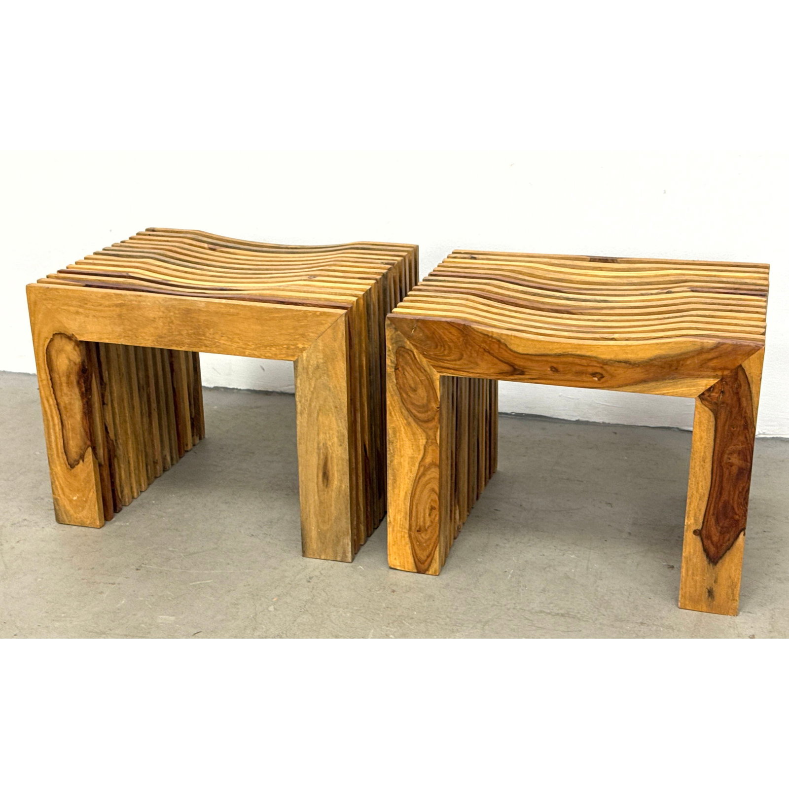 Pair of Contemporary Slatted Exotic Hardwood Stool Benches with Wave Form Undulating Tops and Mitere: Pair of Contemporary Slatted Exotic Hardwood Stool Benches with Wave Form Undulating Tops and Mitered Corners Dimensions: Height: 17.5 inches, Width: 22 inches, Depth: 17.25 inches. ---