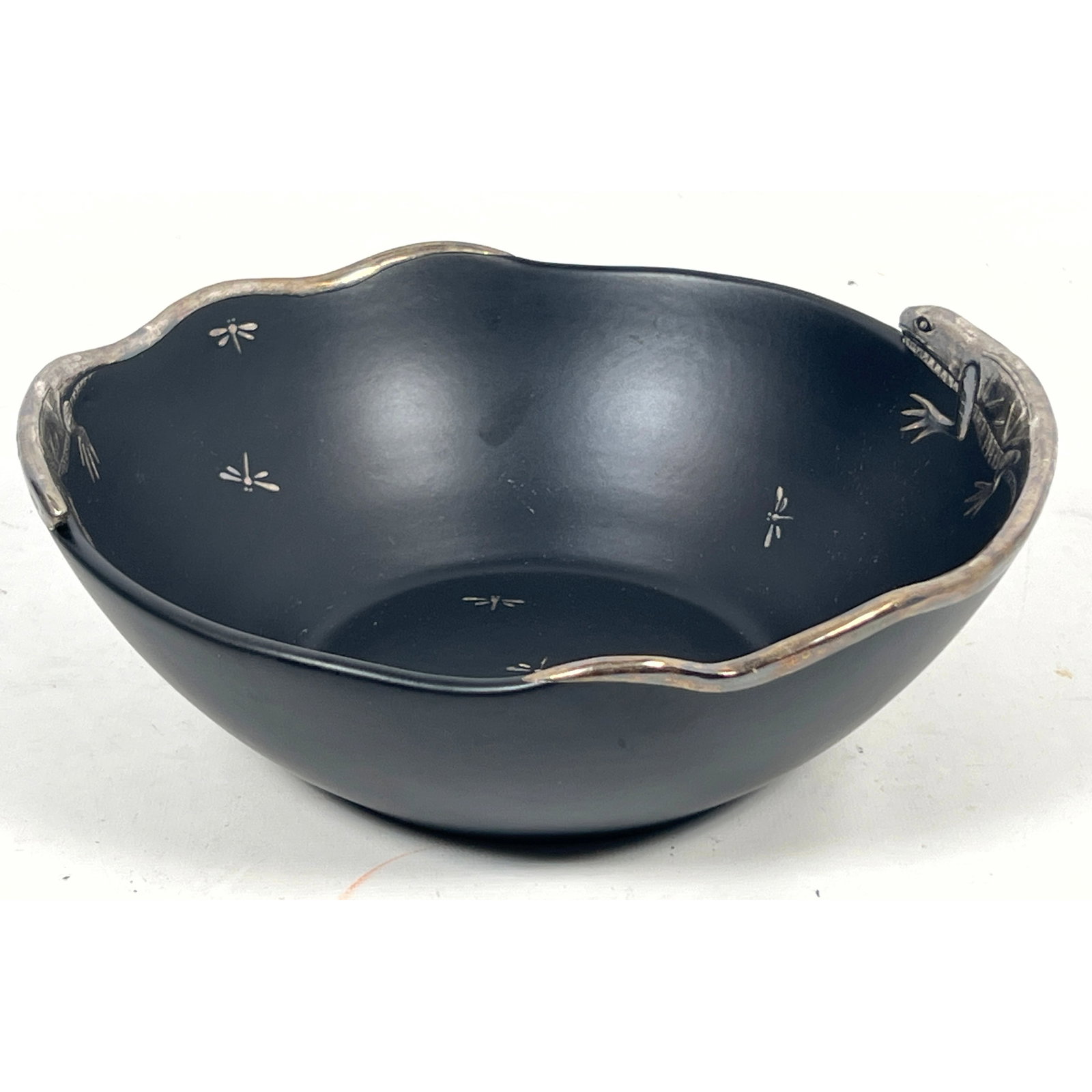Emilia Castillo Taxco Silver Overlay Pottery Bowl: Matte black bowl with silver dragonfly and iguana: Emilia Castillo Taxco Silver Overlay Pottery Bowl: Matte black bowl with silver dragonfly and iguana decoration. Painted silver signed and initialed. Dimensions: Height: 3.5 inches, Width: 9.5 inches,