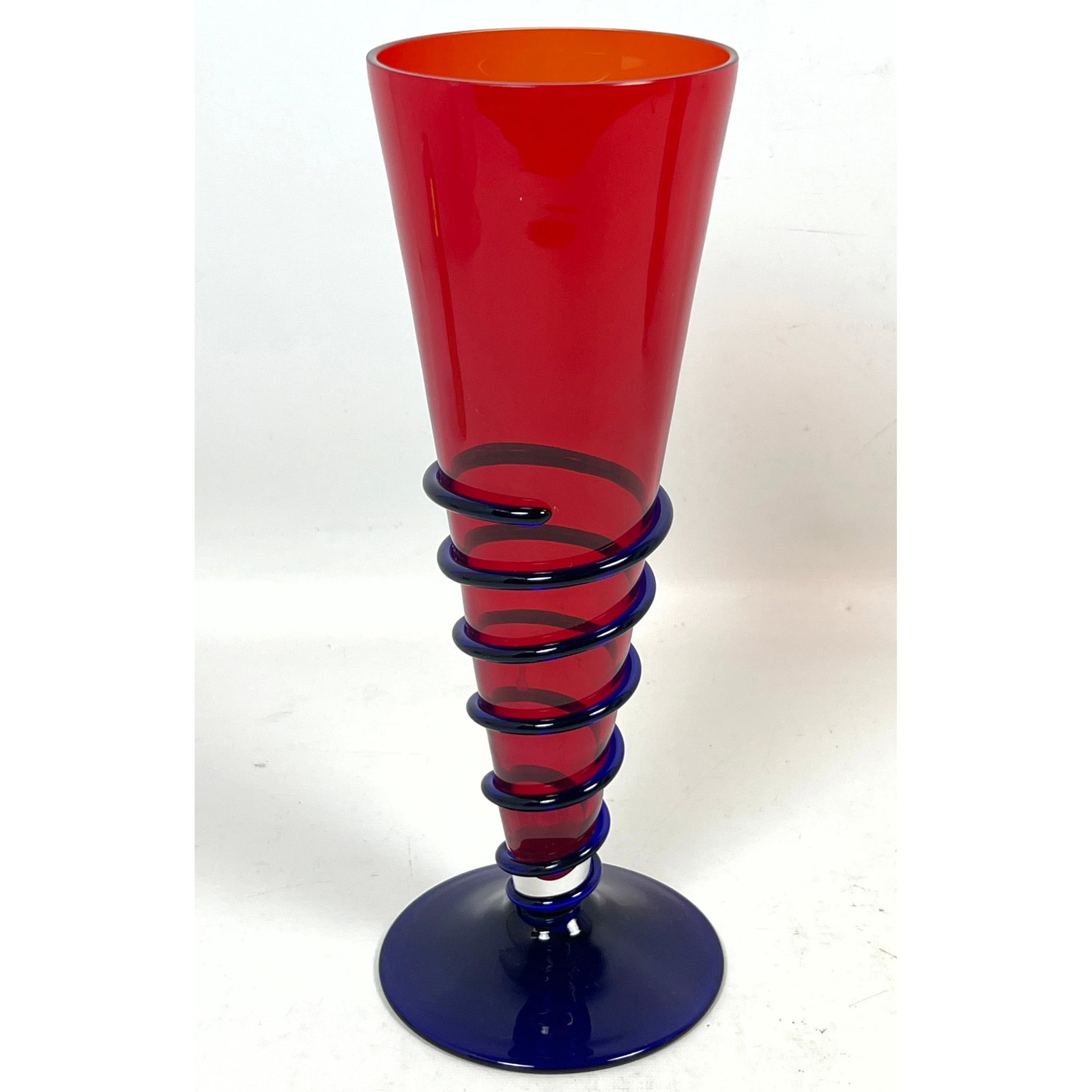 Marcello Furlan Murano art glass conical vase in red with cobalt blue applied spiral wrap and base s: Marcello Furlan Murano art glass conical vase in red with cobalt blue applied spiral wrap and base signed and dated 1992 Dimensions: Height: 11.5 inches, Width: 4 inches, Depth: 4 inches. --- US Packi