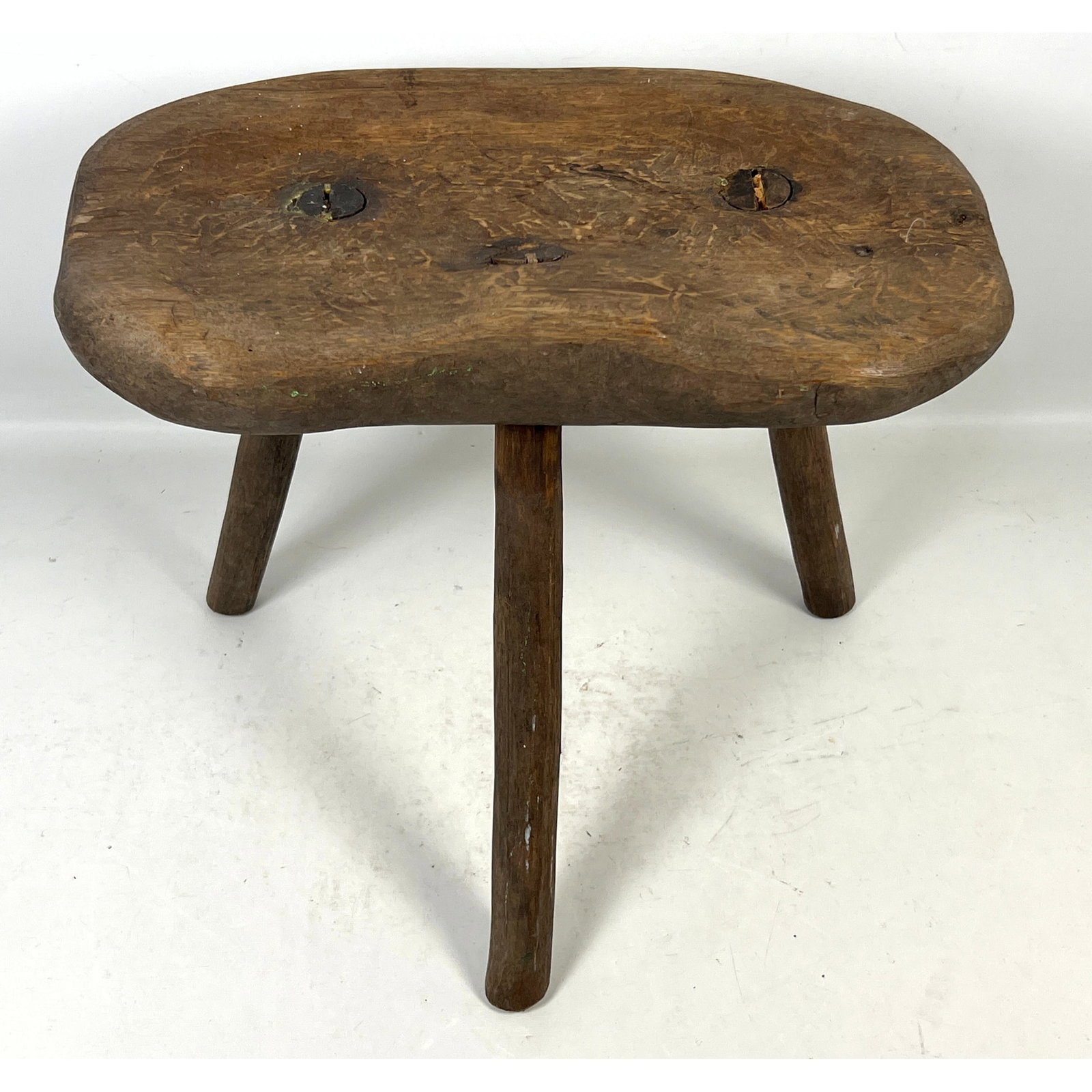 Primitive French 3 Legged Wood Milking Stool with Hand Hewn Construction and Splayed Legs: Primitive French 3 Legged Wood Milking Stool with Hand Hewn Construction and Splayed Legs Dimensions: Height: 15 inches, Width: 18 inches, Depth: 10 inches. --- US Packing and Shipping charge: In hous