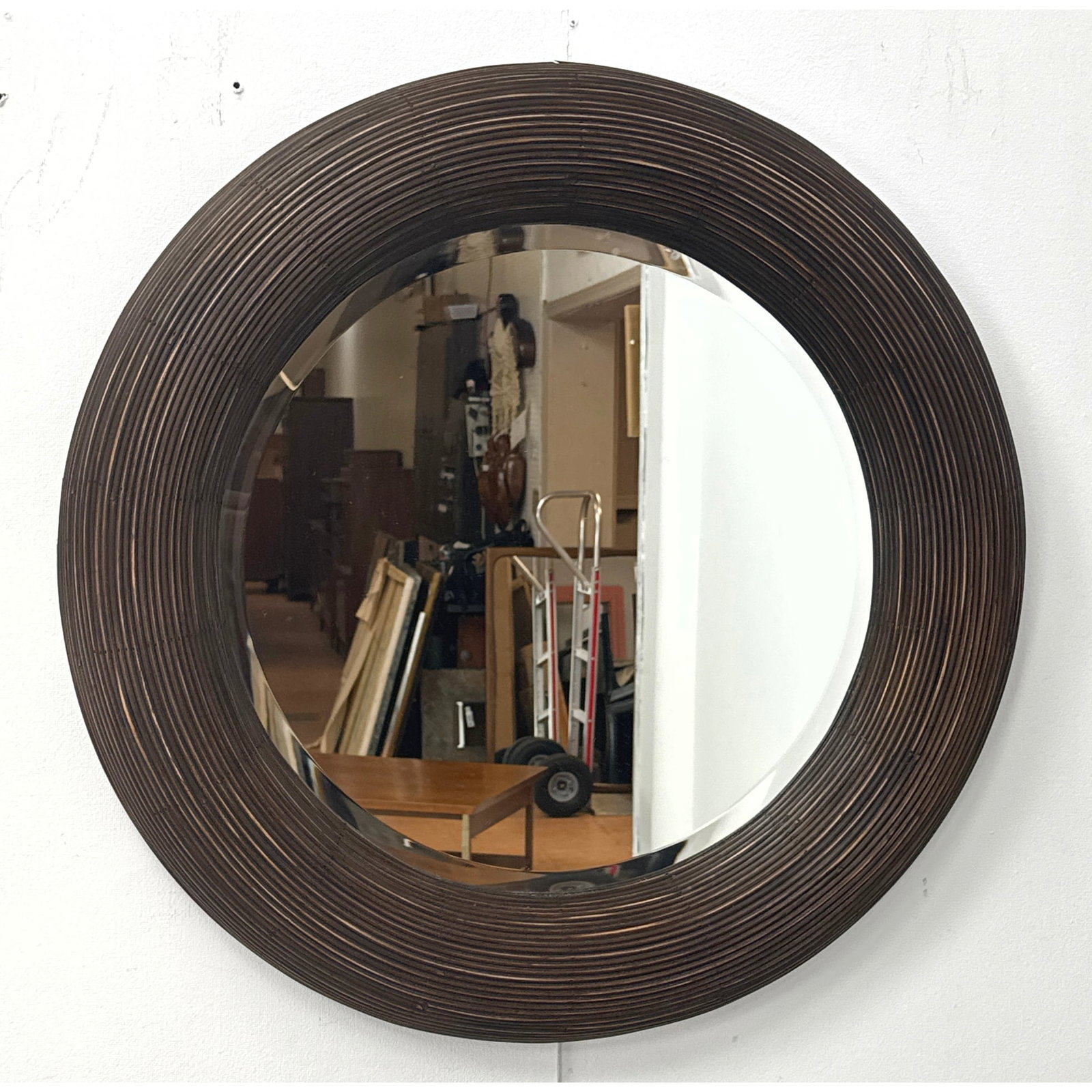 Large Round Pencil Reed Rattan Wall Mirror with Bullseye Convex Frame and Beveled Glass Mirror Plate: Large Round Pencil Reed Rattan Wall Mirror with Bullseye Convex Frame and Beveled Glass Mirror Plate. Unsigned. Dimensions: Height: 29 inches, Width: 29 inches, Depth: 2.5 inches. ---