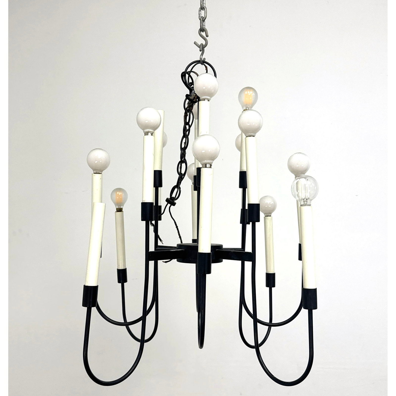 Mid Century Modern 16 Light Black Metal Chandelier Attributed to Lightolier with Curved Arms and Cre: Mid Century Modern 16 Light Black Metal Chandelier Attributed to Lightolier with Curved Arms and Cream Candle Sleeves Dimensions: Height: 26.5 inches, Width: 23 inches, Depth: 23 inches. ---