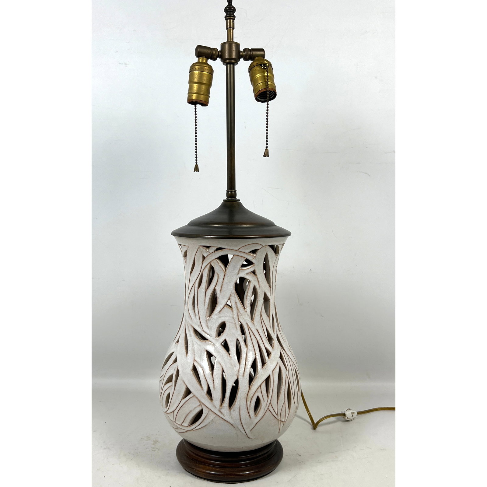 Reticulated White Glazed Ceramic Table Lamp on Turned Wood Base with Double Socket Cluster and Twin: Reticulated White Glazed Ceramic Table Lamp on Turned Wood Base with Double Socket Cluster and Twin Pull Chain Switches. Vintage. Dimensions: Height: 26.5 inches, Width: 8 inches, Depth: 8 inches. ---