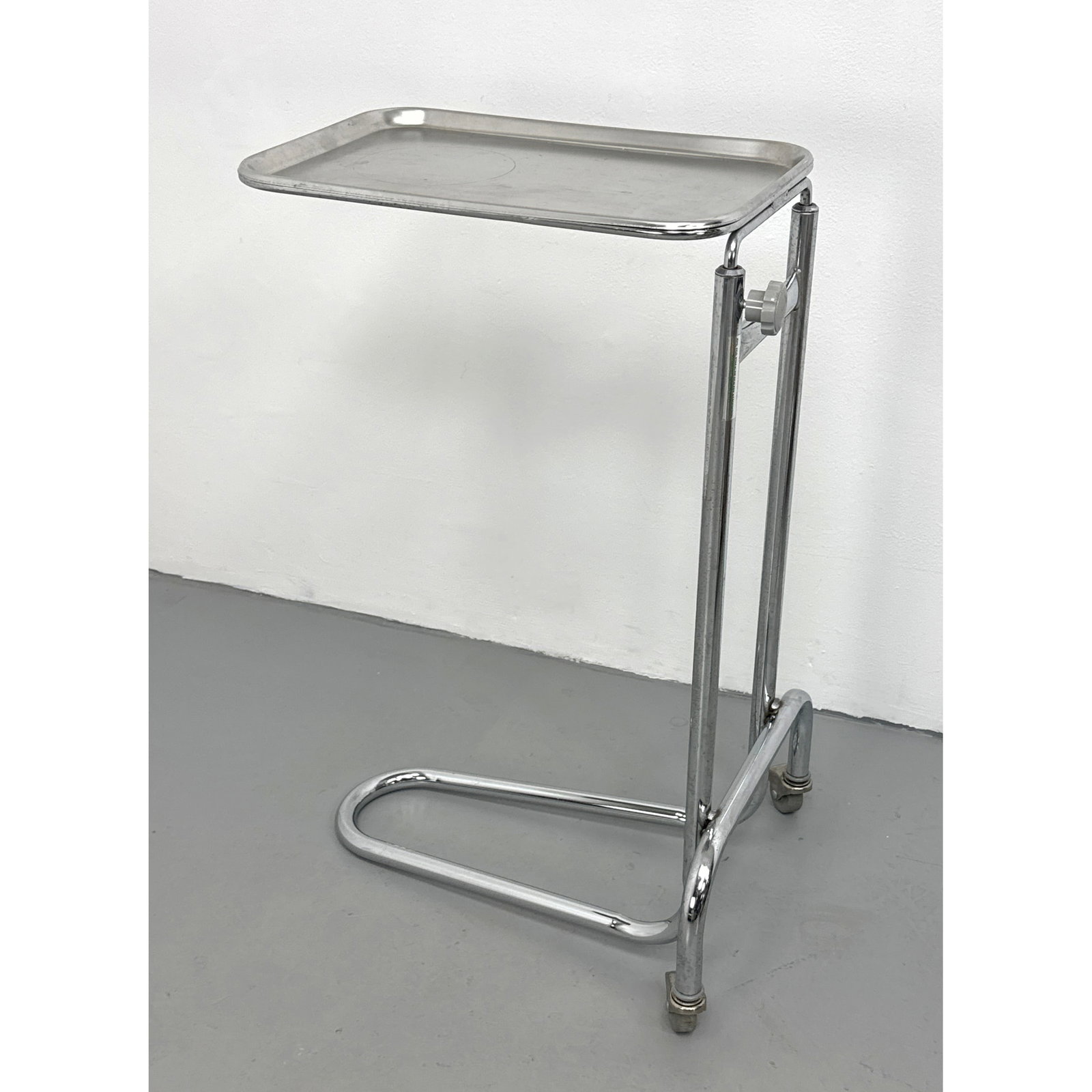 Starline height-adjustable medical Mayo stand with a cantilevered chrome-plated steel frame.: Starline height-adjustable medical Mayo stand with a cantilevered chrome-plated steel frame. Dimensions: Height: 31.75 inches, Width: 20.5 inches, Depth: 17 inches. ---