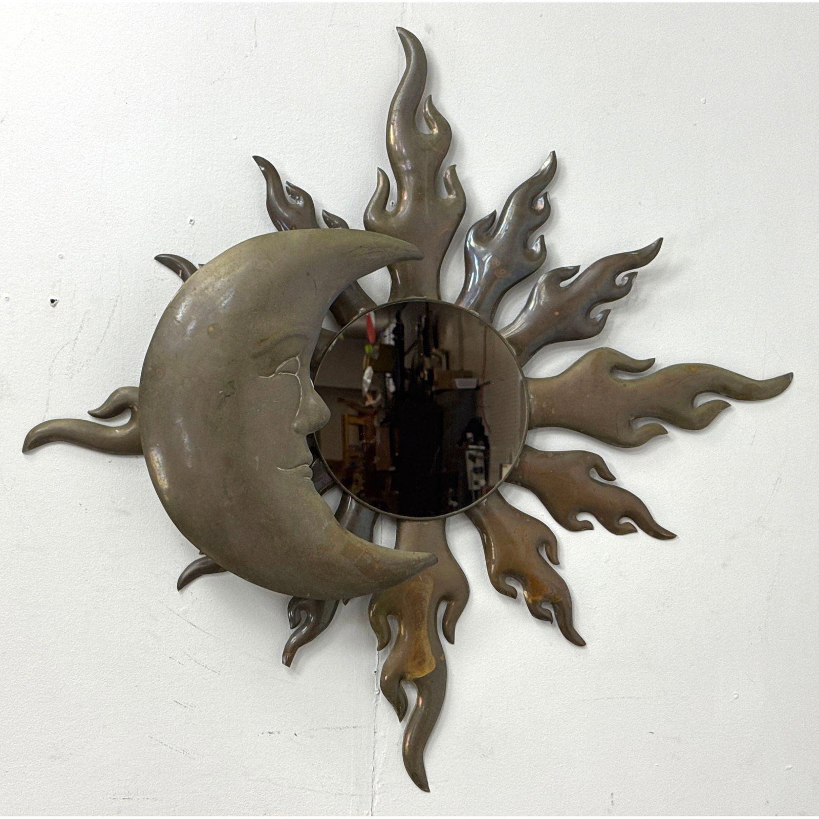 Vintage Brutalist style patinated Brass sun and moon wall mirror with integrated backlit sconce: Vintage Brutalist style patinated Brass sun and moon wall mirror with integrated backlit sconce Dimensions: Height: 37 inches, Width: 38 inches, Depth: 4.5 inches. ---