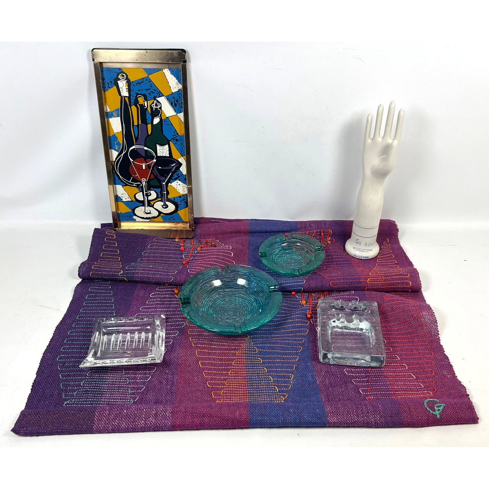 Mid Century Modern decor including Signed Nicolas Still Life Tray, General Porcelain Glove Mold, Art: Mid Century Modern decor including Signed Nicolas Still Life Tray, General Porcelain Glove Mold, Artisan Textile Runner, and 4pc Glass Ashtray Lot Dimensions: Height: 18.5 inches, Width: 8.25 inches, 