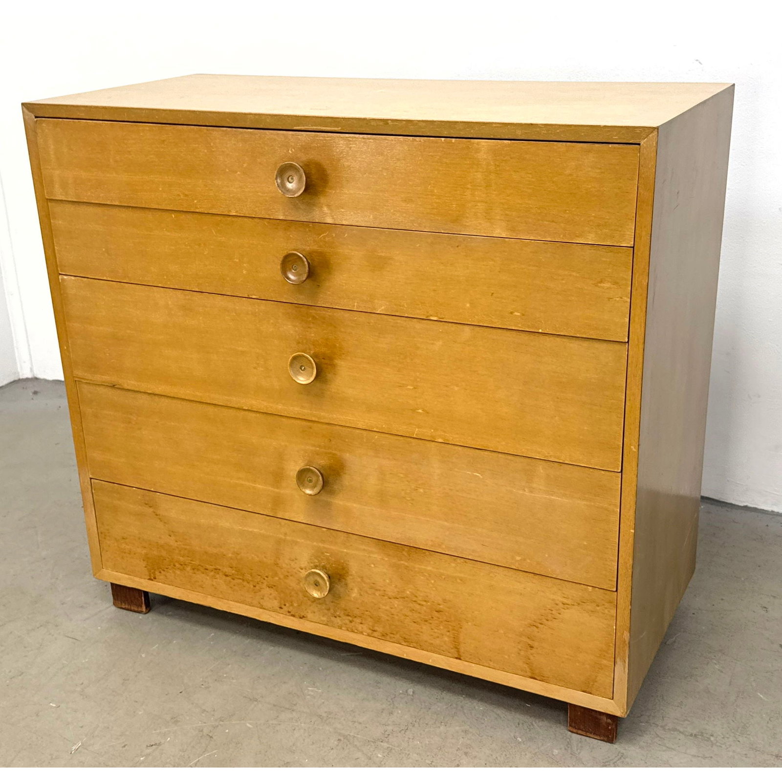Mid Century Modern 5 Drawer Maple Veneer Dresser with Concave Wooden Pulls and Metal Bandingwear and: Mid Century Modern 5 Drawer Maple Veneer Dresser with Concave Wooden Pulls and Metal Bandingwear and some veneer lifting. Dimensions: Height: 37 inches, Width: 40 inches, Depth: 18.5 inches. ---