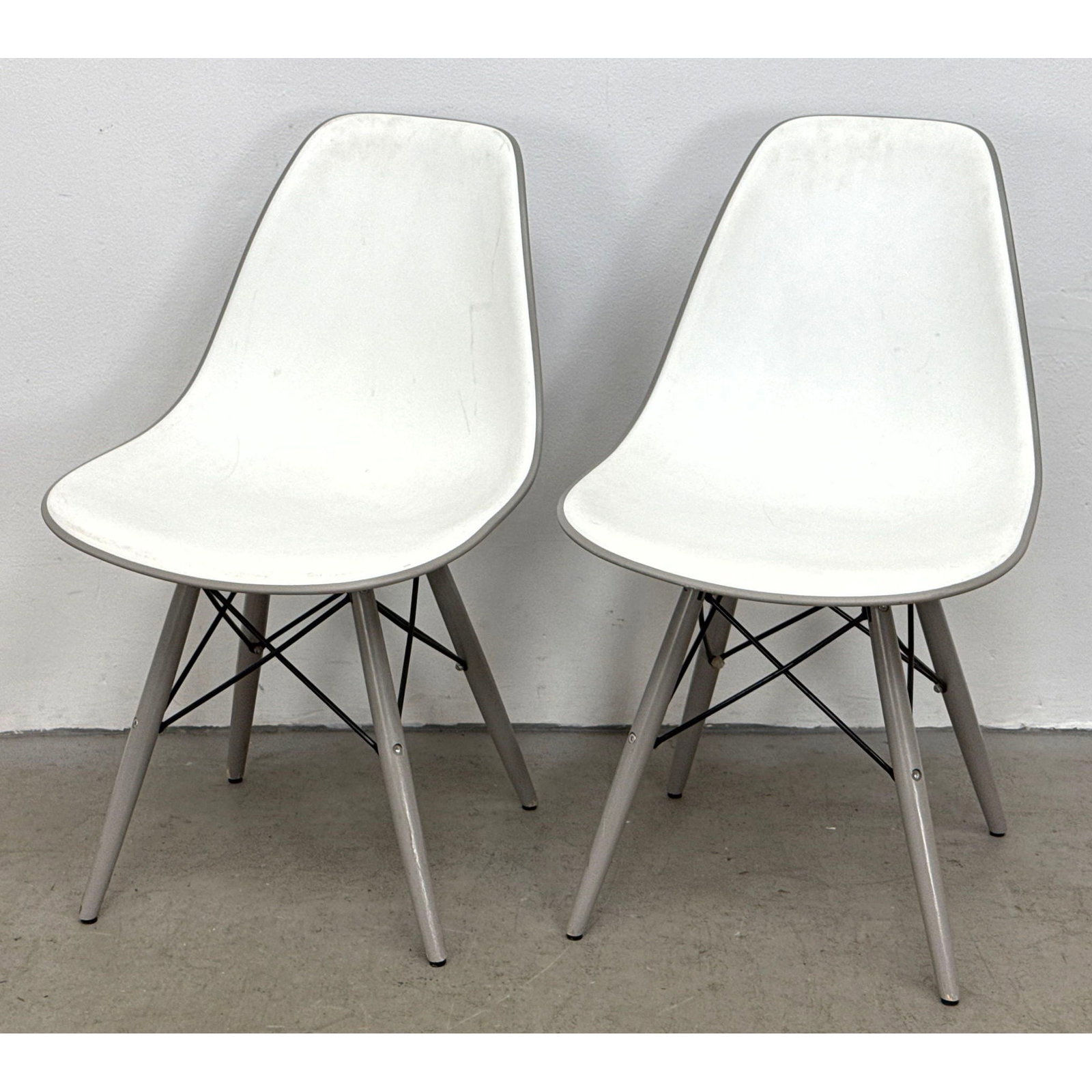 Pair of Eames style white polypropylene molded side chairs with gray painted legs and black wire bra (1 of 10)
