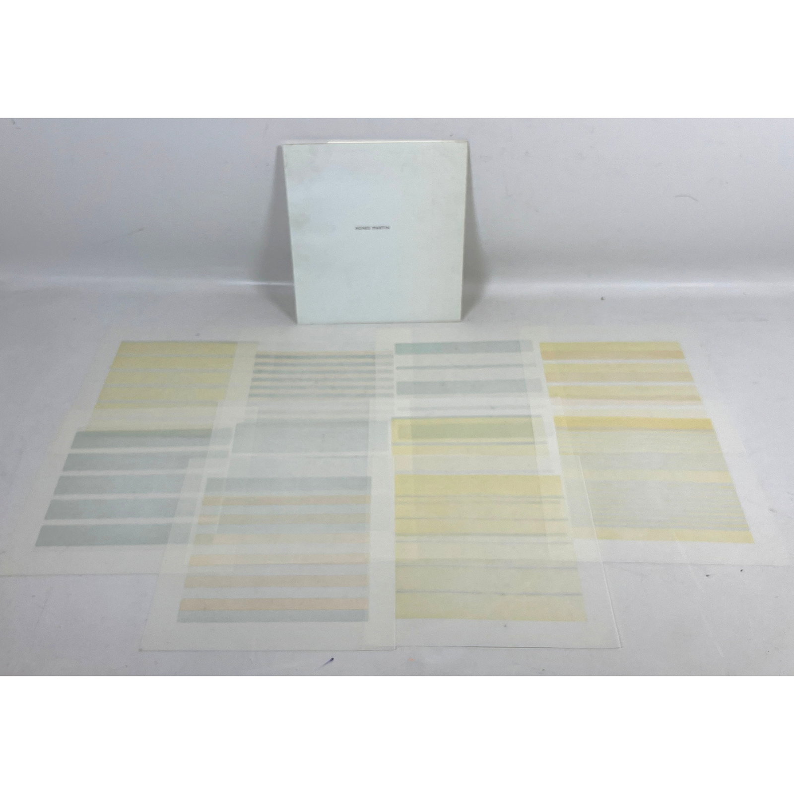 Set 10 Agnes Martin Color Lithographs on Vellum in original portfolio case titled Agnes Martin: Set of 10 Agnes Martin Color Lithographs on Vellum in original portfolio case titled Agnes Martin Dimensions: Height: 11 inches, Width: 10.5 inches. --- US Packing and Shipping charge: $20 Plus