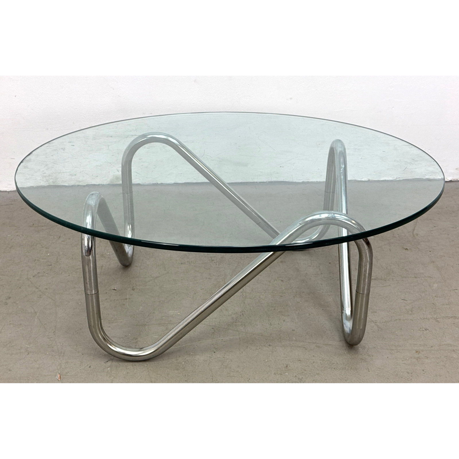 1970s French style sculptural tubular chrome and round glass top coffee table with a serpentine base (1 of 7)