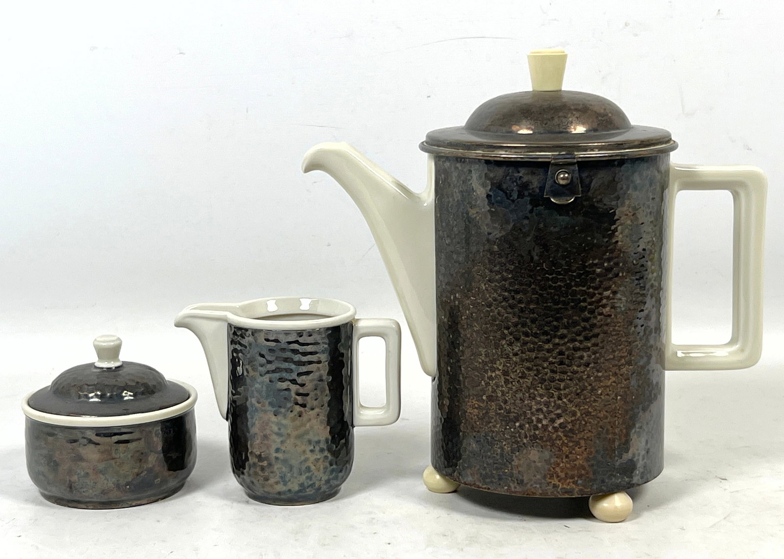 3pc WMF Ikora Art Deco Silver Plated and Ceramic Insulated Beverage Service including Coffee Pot Cre: 3pc WMF Ikora Art Deco Silver Plated and Ceramic Insulated Beverage Service including Coffee Pot Creamer and Sugar Bowl. Dimensions: Height: 10 inches, Width: 9.5 inches, Depth: 5.5 inches. --- US Pac