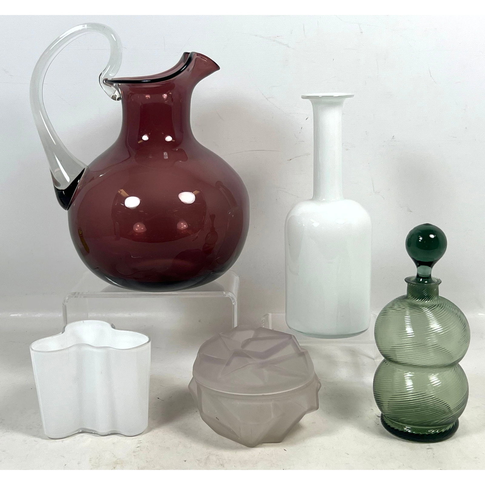 5pcs Mid Century Modern Art Glass Including Marked Alvar Aalto White Vase, Attributed to Cambridge G: 5pcs Mid Century Modern Art Glass Including Marked Alvar Aalto White Vase, Attributed to Cambridge Glass Amethyst Ball Jug, Holmgaard Bottle vase, Ruba Rombic Style covered box. Dimensions: Height: 10