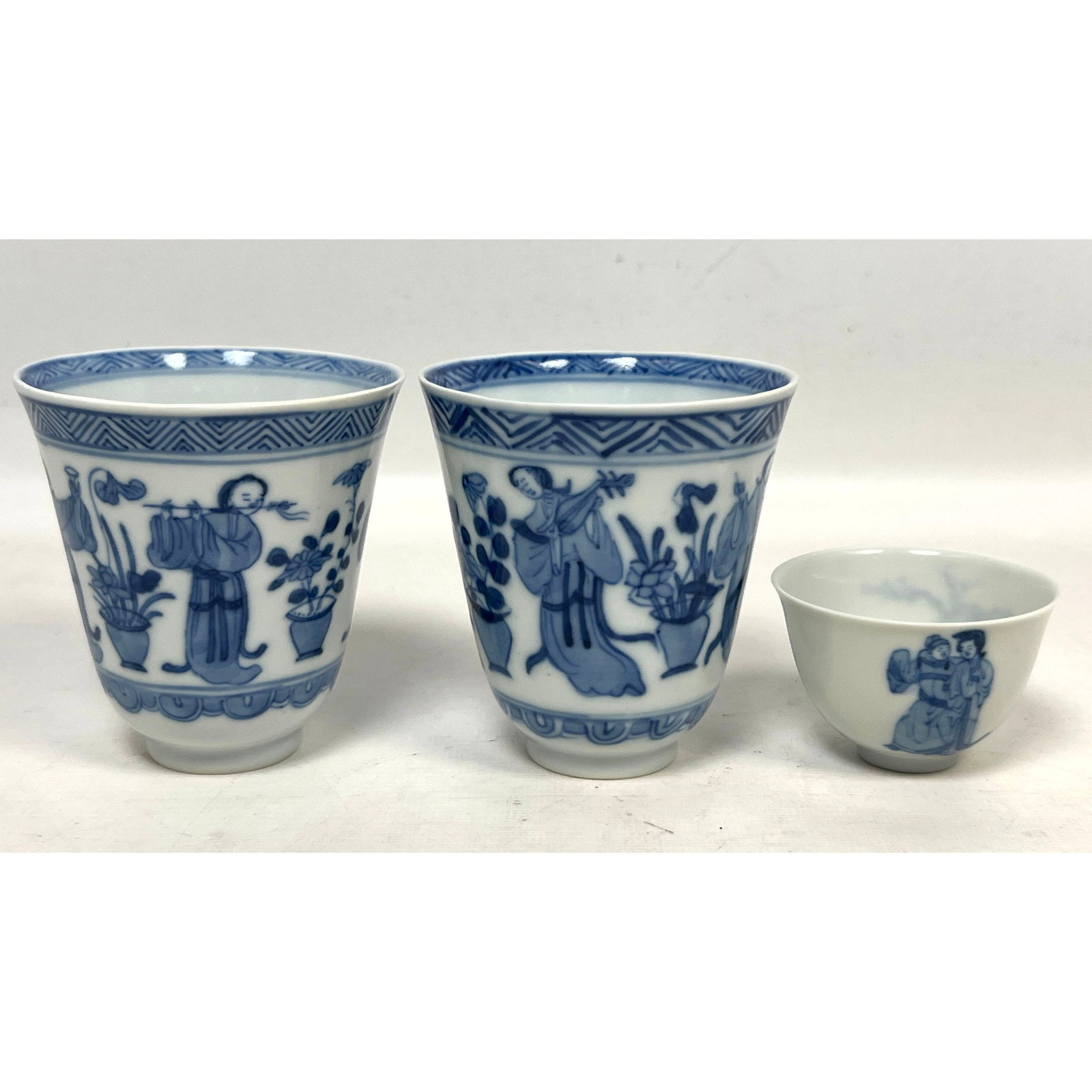 3pcs Blue and White Porcelain Cups including a Pair of Chinese Style Musician Beakers and one Japane: 3pcs Blue and White Porcelain Cups including a Pair of Chinese Style Musician Beakers and one Japanese Kutani Cup Dimensions: Height: 3 inches, Width: 3 inches, Depth: 3.25 inches. --- US Packing and 